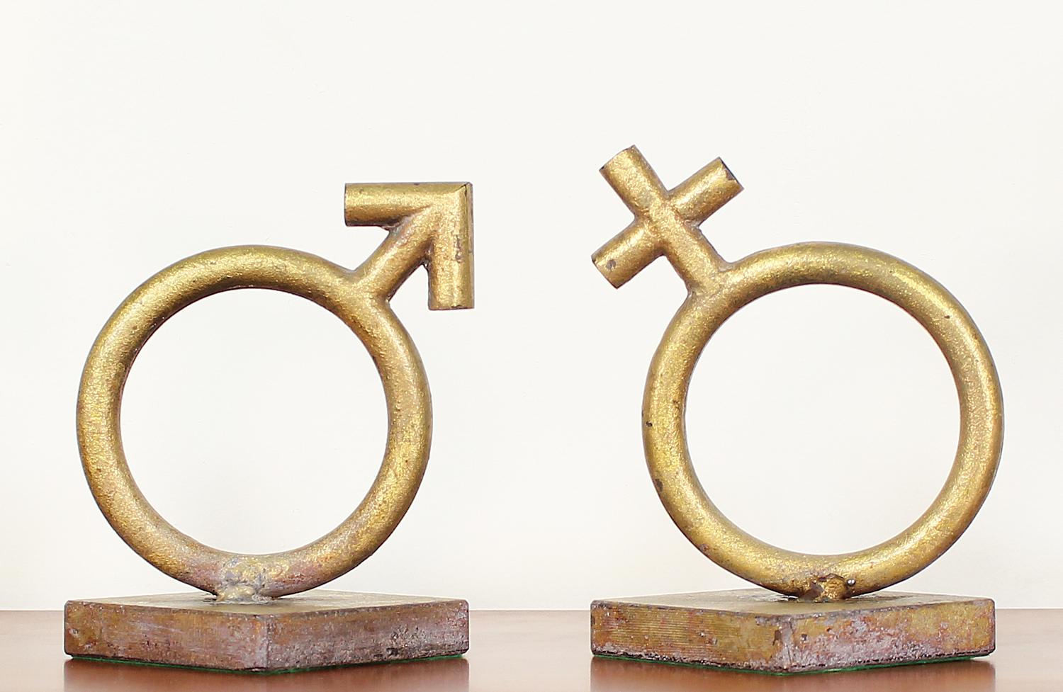 Sex Symbol bookends designed by Curtis Jere for Artisan House in the United States circa 1970’s. This beautiful set of bookends is made with heavy gold leaf metal in its original condition, showing wear from age and use. Both signs display a vintage