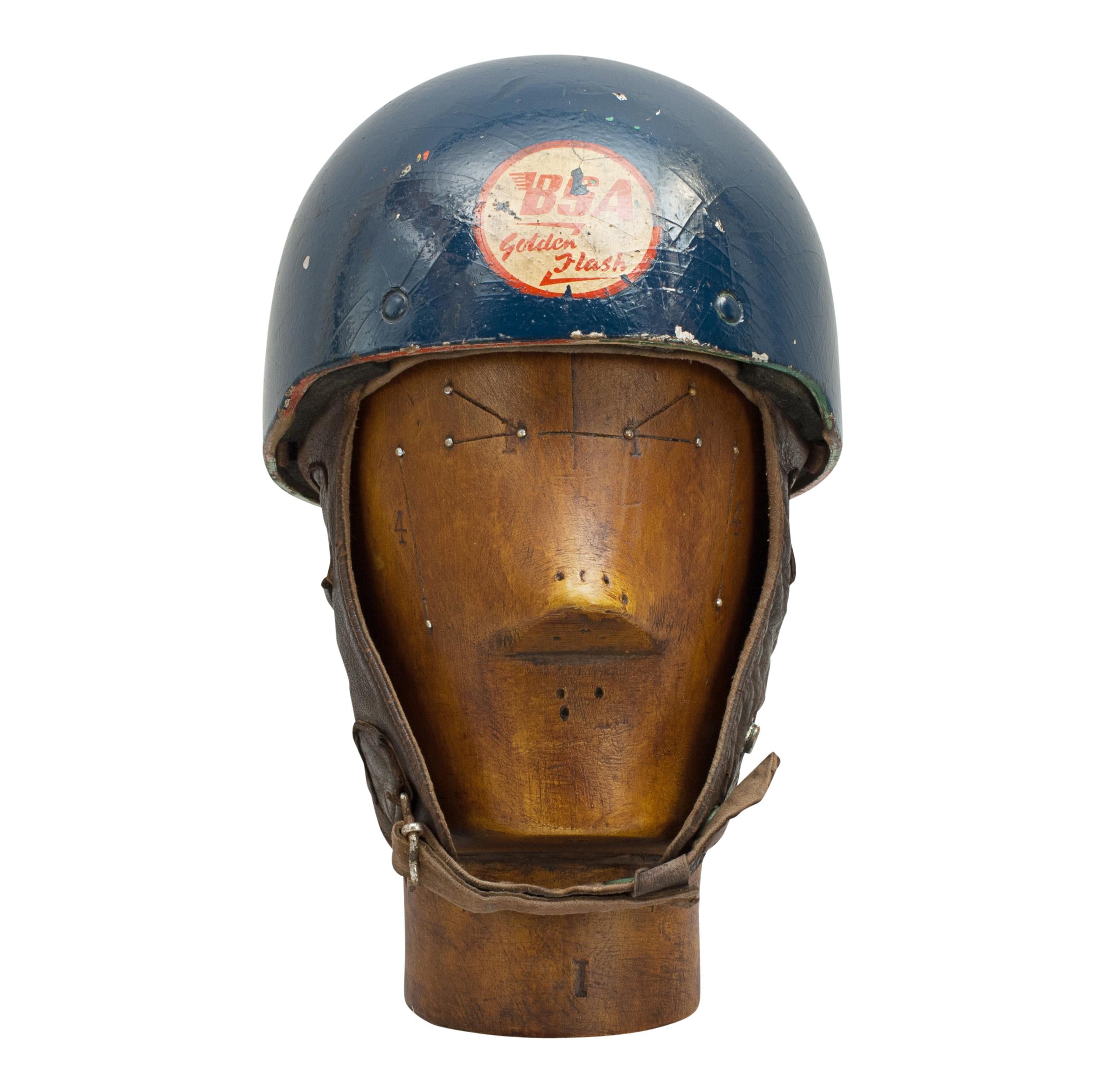 Motorcycle helmet.
A dark blue helmet made in England by Cromwell, The 'Noll'. The pudding basin motorcycle helmet is fitted with a material headband and straps keeping a space between the head and outer case of the helmet. Strong neck and ear