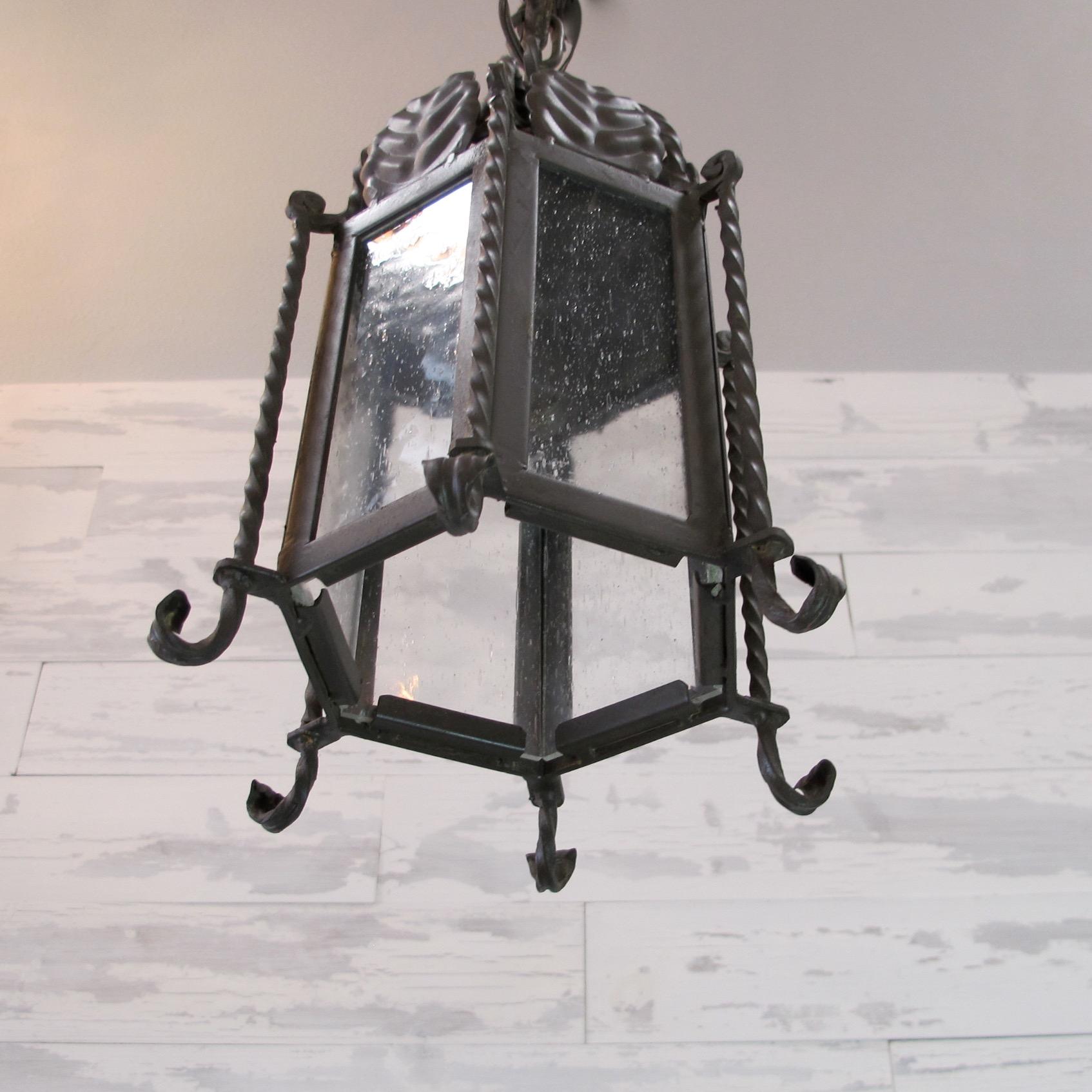 Pair of Small Forged Iron Lanterns with Seeded Glass In Excellent Condition For Sale In Encinitas, CA