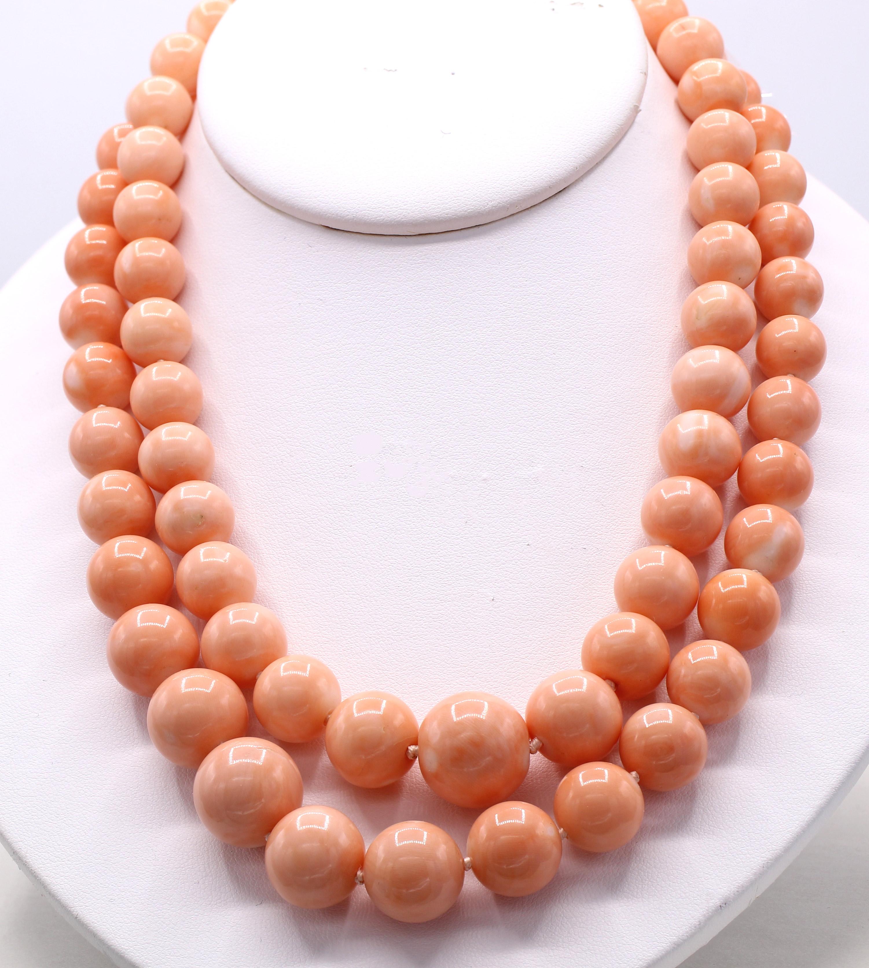 Beautifully matched pair of angel skin coral bead necklaces by David Webb. The longer necklace with a length of 30 inches has coral beads graduating from 15.75 millimeters down to 10 millimeters while the shorter necklace with a length of 25 inches