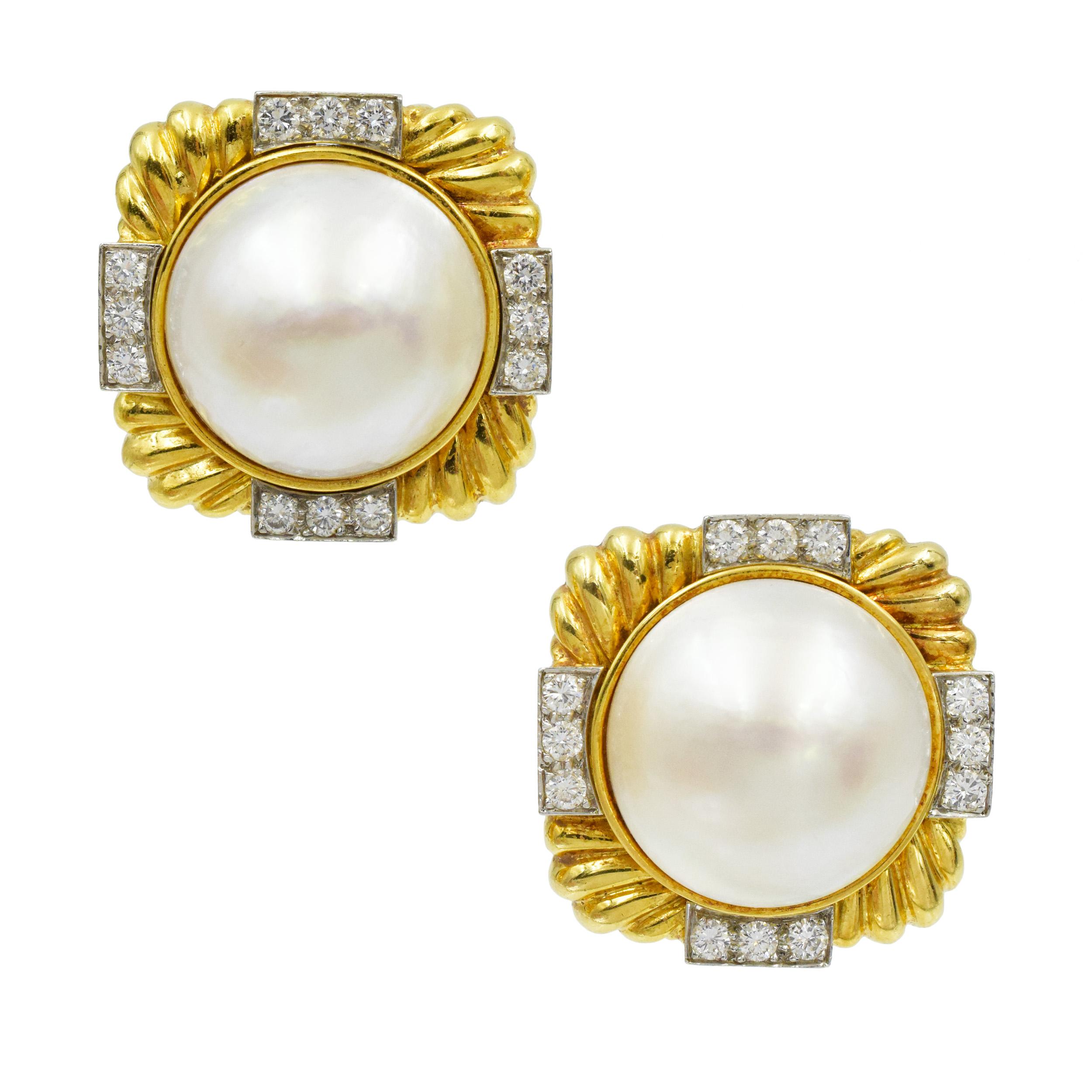 David Webb Diamond and Pearl earrings in 18k yellow gold and platinum. These earrings have mabe- pearl centers set in 18k yellow fluted gold
earrings with 24 round diamonds weighing approximately 1.20 carats total. Equipped
with Clip backs.