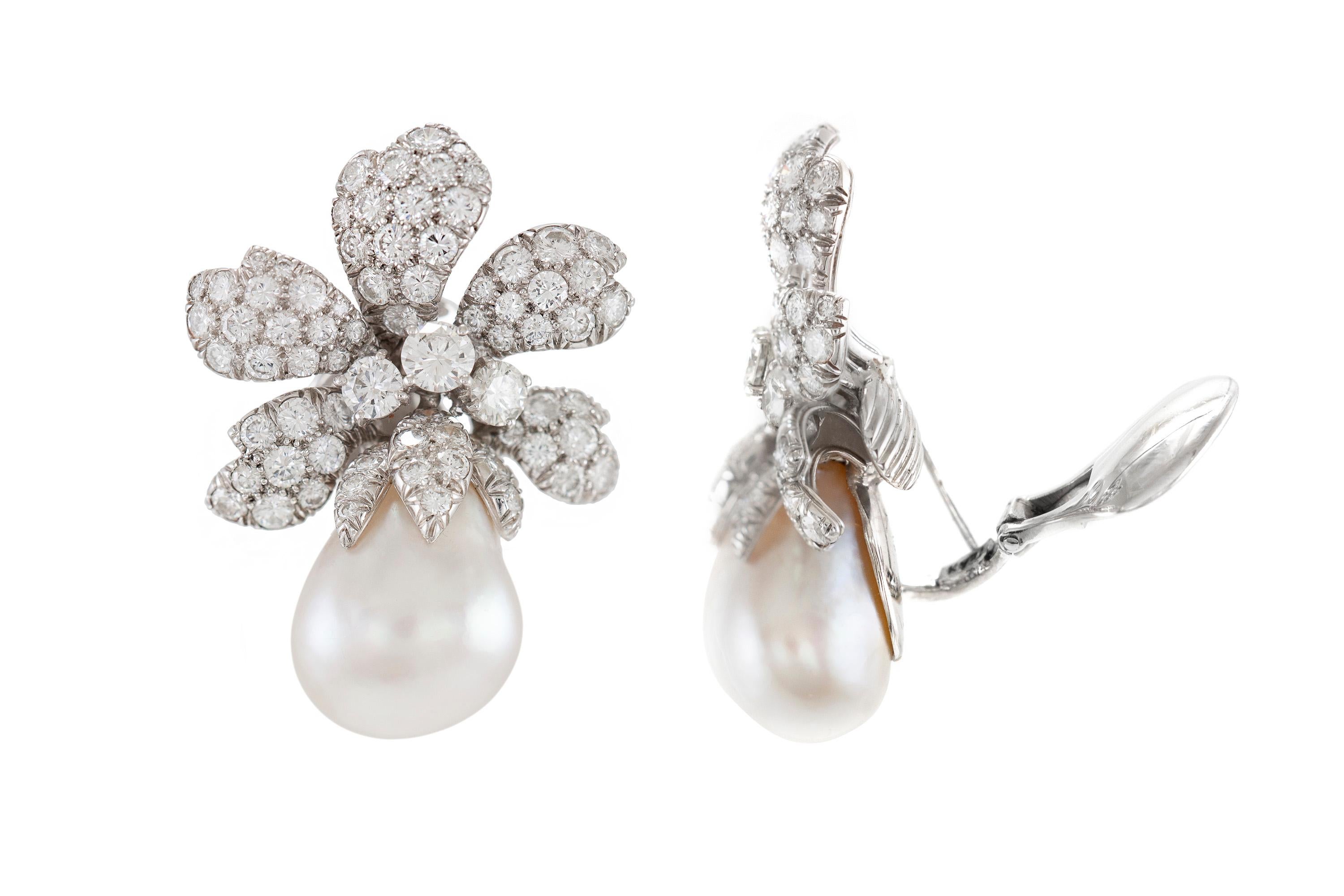 Finely crafted in platinum with South Sea Pearls and round brilliant cut diamonds weighing a total of 11.73 carats.
The earrings are 1 3/4 inch long, 1 1/8 inch wide.
The size of the pearls are approximately 22 mm x 16.5 mm
Signed by David