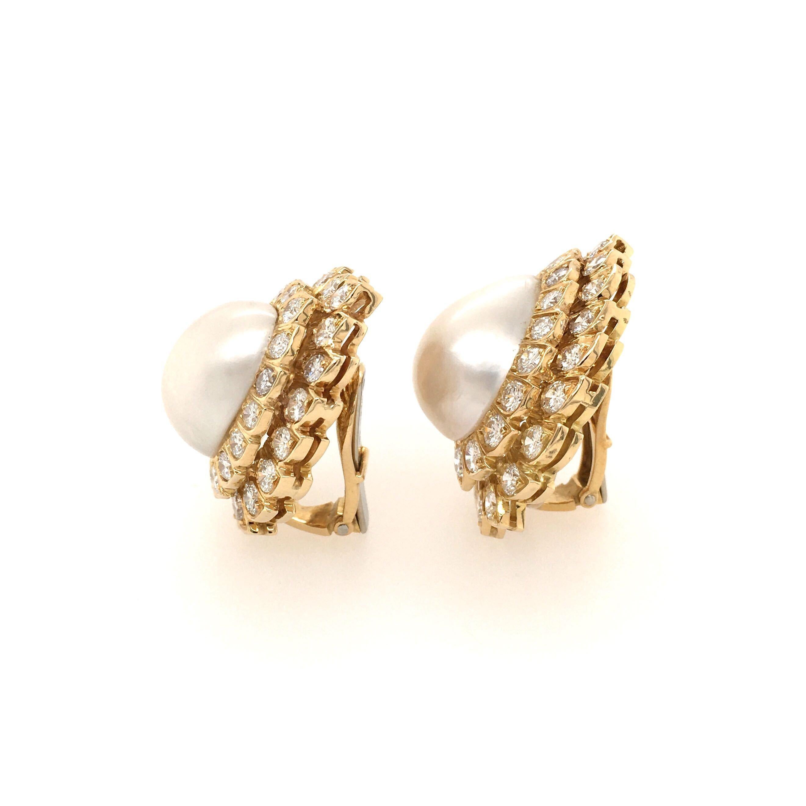 A pair of 18 karat yellow gold, pearl and diamond earclips, David Webb.  Each earclip centering a pear shaped mabe pearl surrounded by thirty four (34) brilliant cut diamonds of various sizes in two tiers.  Length approximately 1 1/4 inches.  Gross
