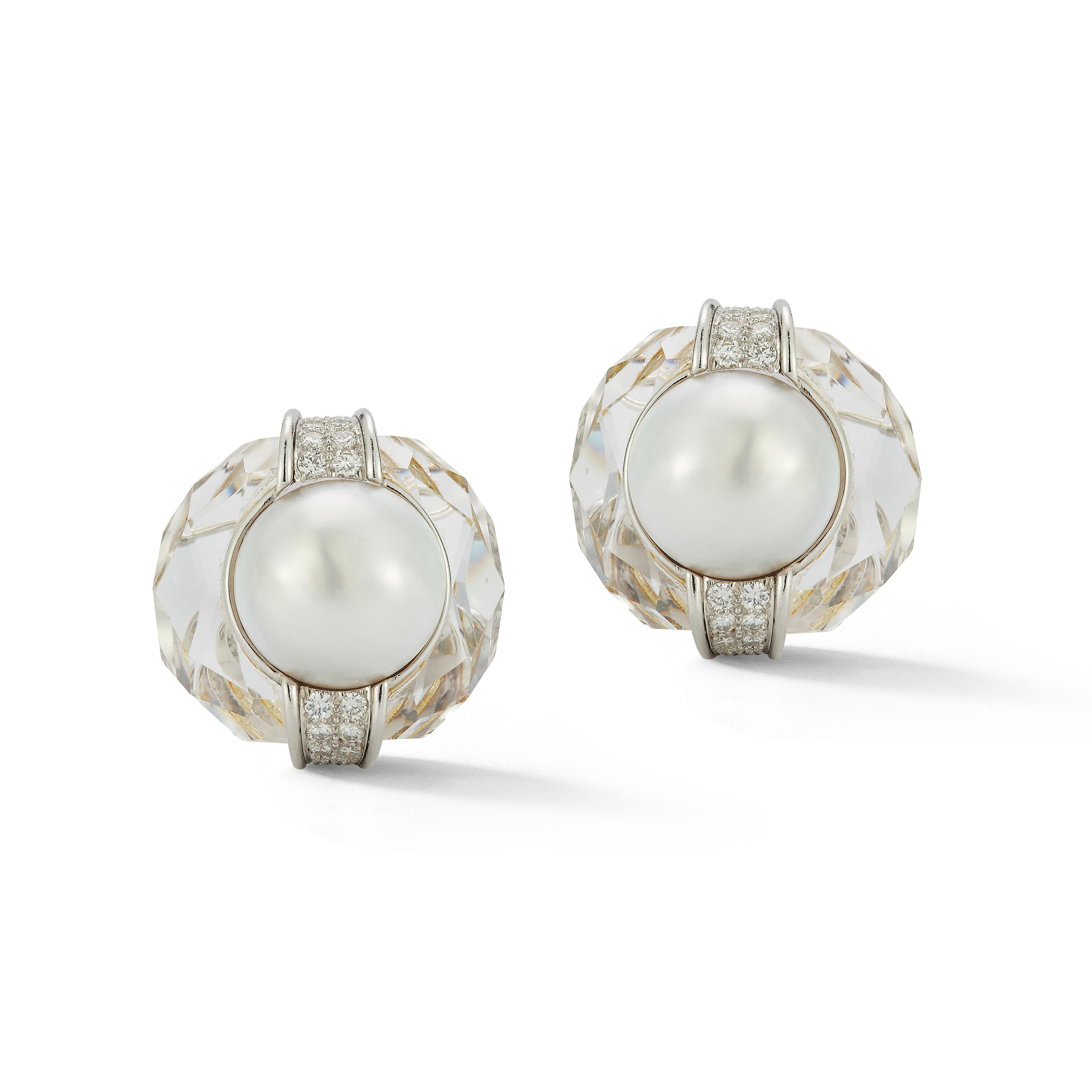 David Webb Pearl & Rock Crystal Earrings
 
A pair of cultured pearls surrounded by faceted rock crystal and round cut diamonds.

Circa 1970

Measurements: 1.25
