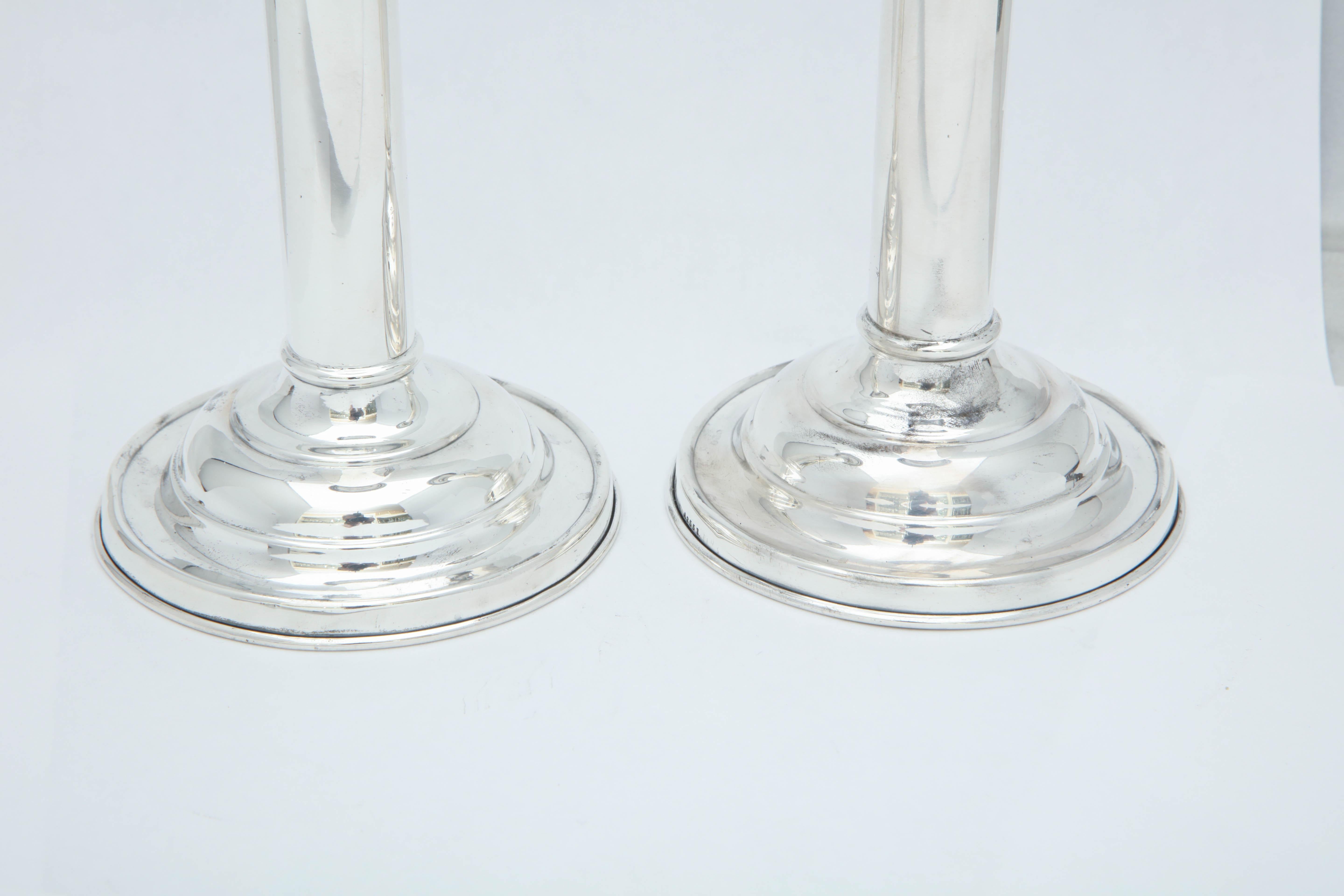 Edwardian pair of sterling silver candlesticks, The Gorham Manufacturing Company, Providence, Rhode Island, circa 1910. Clean lines. Each measures 7 inches high x 3 3/4 inches in diameter across base. Weighted. Dark spots in photos are reflections.