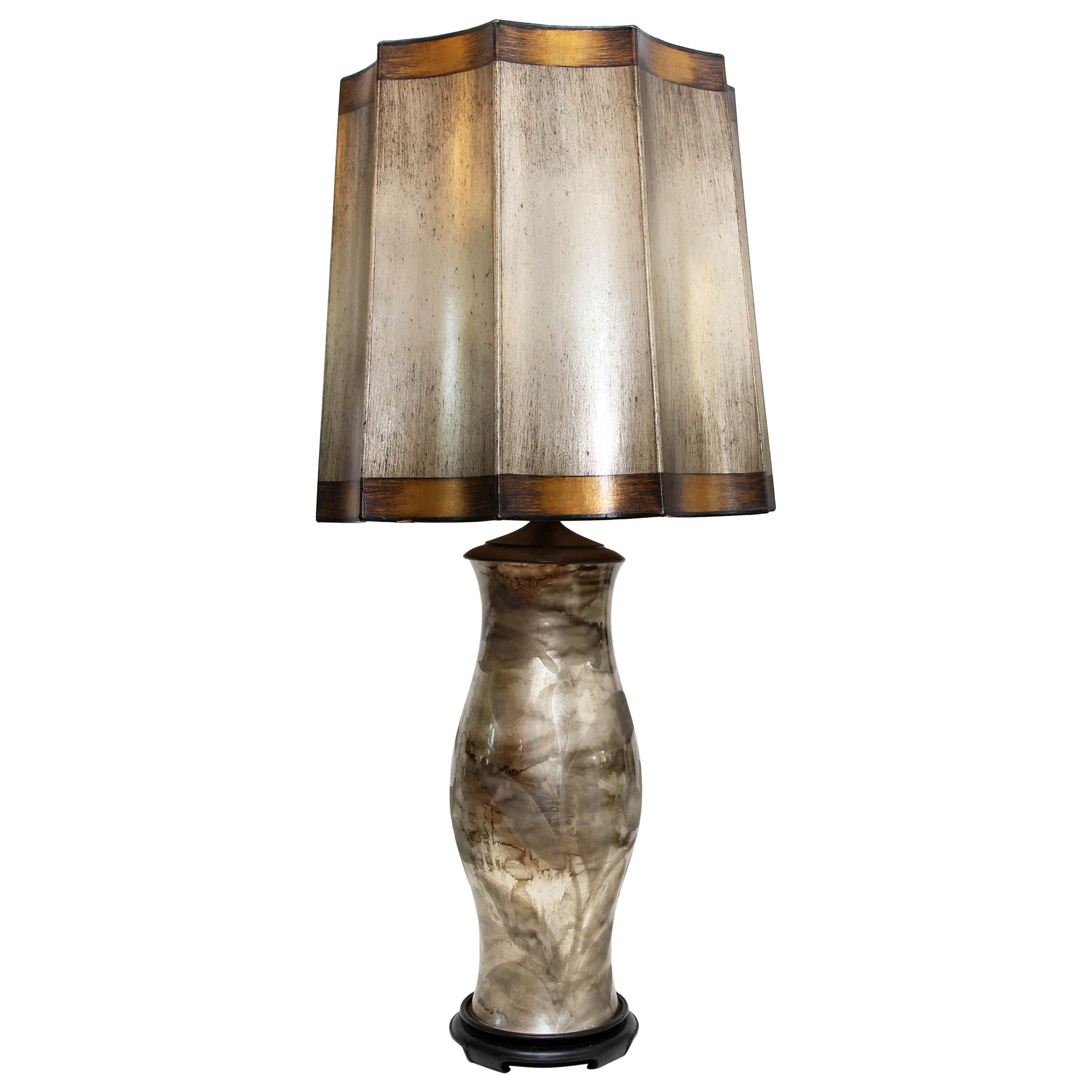 Pair of unique Mid-Century Modern lamps. Gilt and painted original shades. Glass bases with silver gilding on interior. Exterior of glass is etched with floral design.