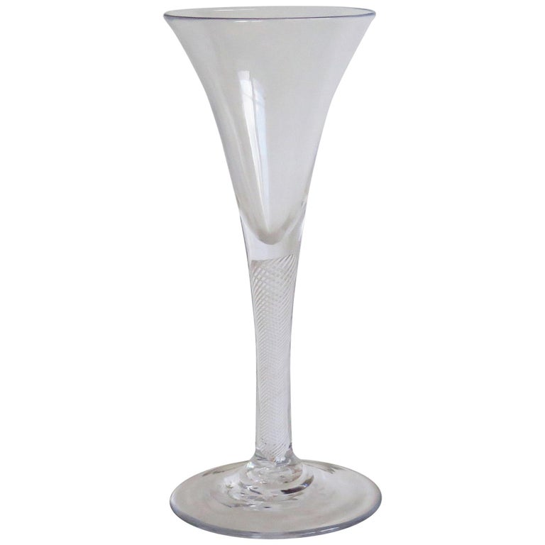 This is a good tall handblown, English, mid-Georgian, Wine drinking glass with a multi spiral opaque twist (MSOT) or Cotton Twist stem, dating from the middle of the 18th century, circa 1760. 

These hand-blown wine glasses are very collectable. It