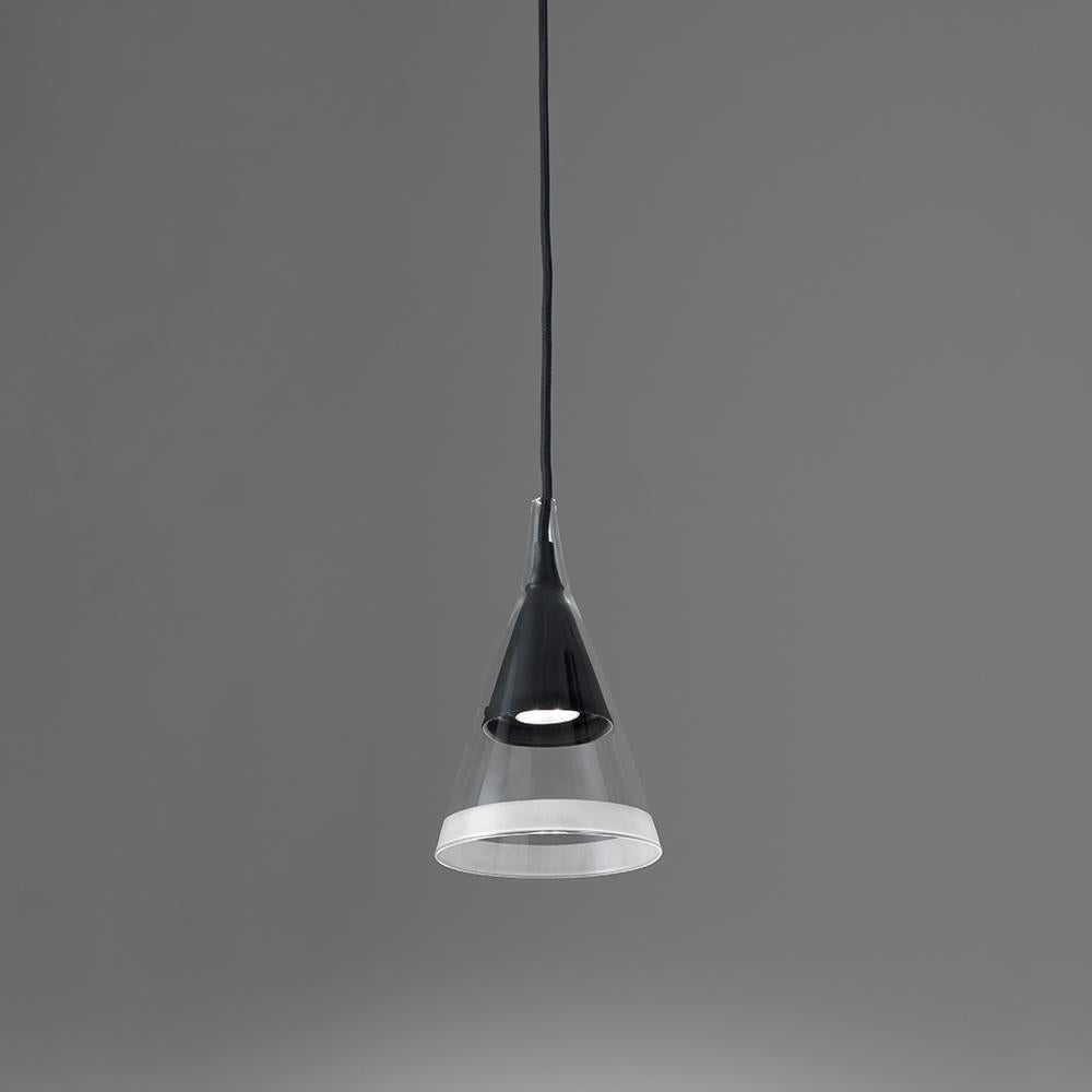 Vigo reinterprets the concept of an old-fashioned street light for domestic environment.

Consisting of dual overlapping cones with one placed inside and flush with its mate. The inner cone is made of black metal while the outer is transparent,