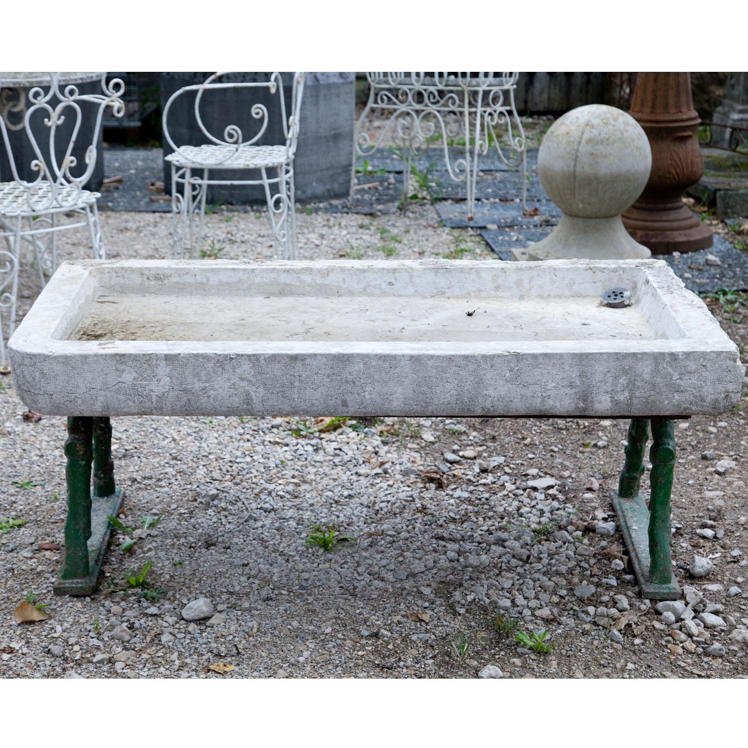 Large marble sink with a rectangular shape and a low rim.