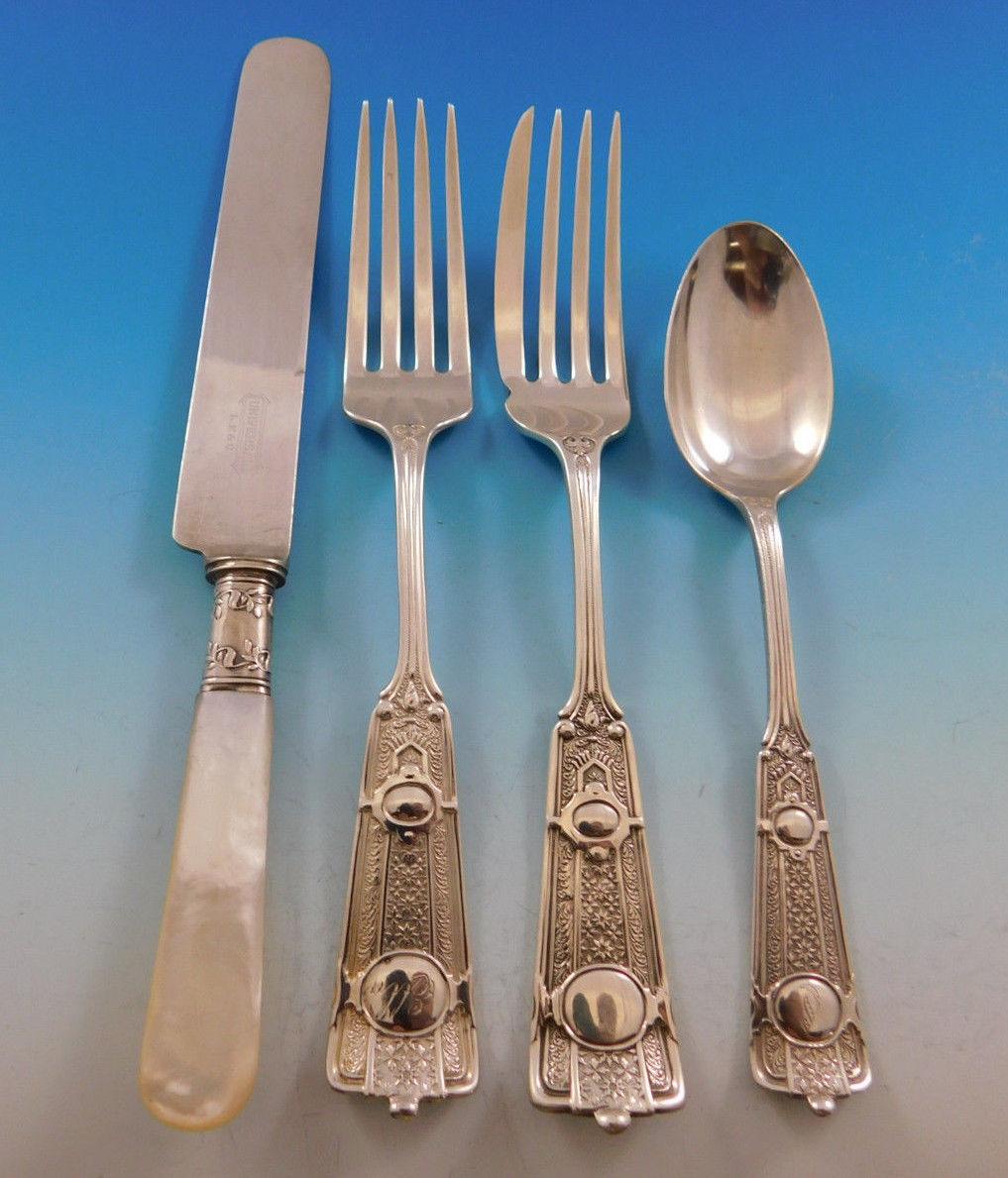 Rare Ribbon by John R. Wendt, circa 1870 sterling silver Moresque style flatware set - 49 pieces, with of stylized tendrils and leaves, with two central medallions. This set includes:

Eight knives, mother-of-pearl handles with sterling ferrules, 8