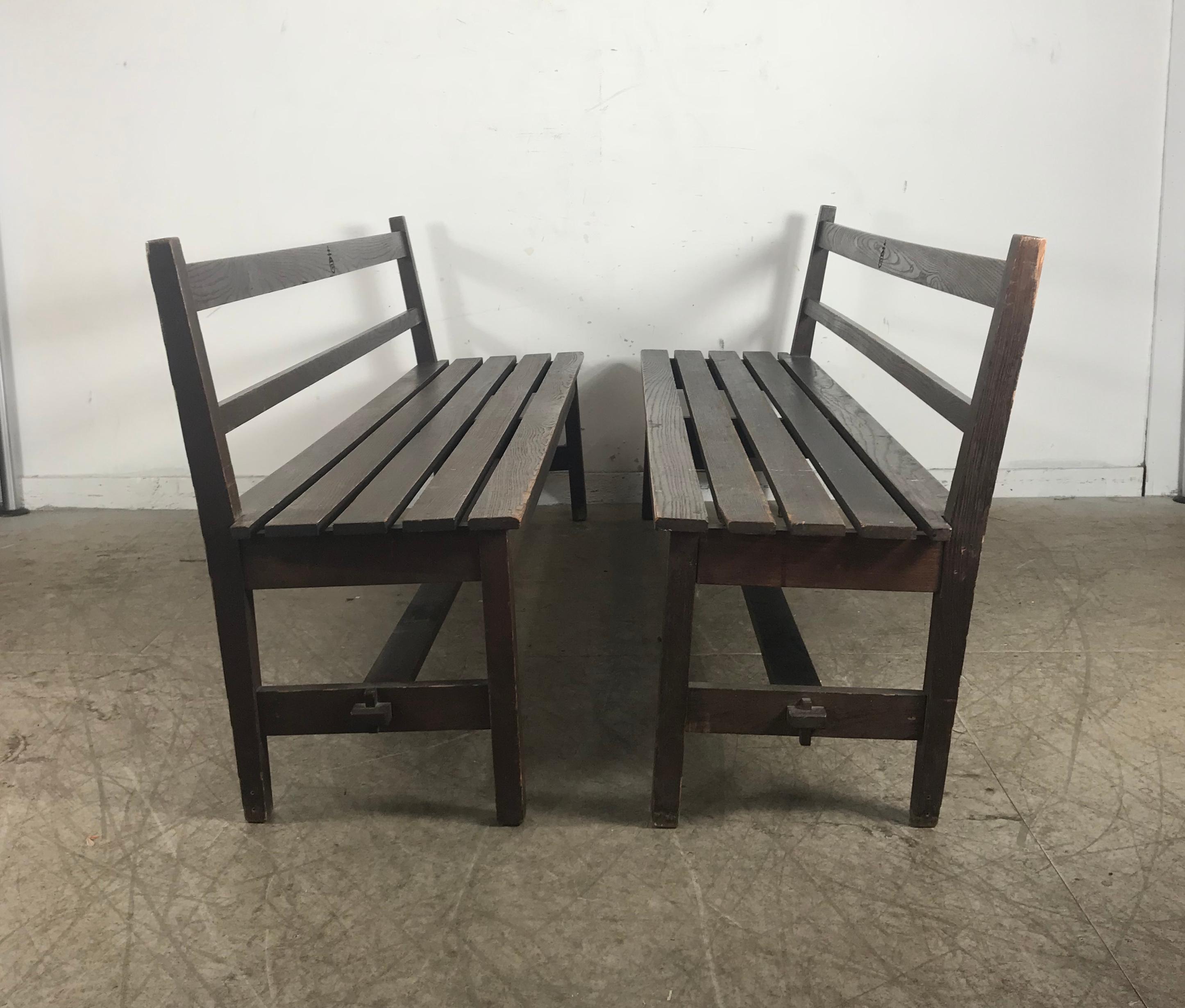 Rare pair of Roycroft oak benches, inventory numbered, custom built exclusively for the Roycroft Inn, East Aurora NY. Amazing quality and construction, retain original Roycroft orb mark as well as incised inventory numbers. Hand delivery avail to