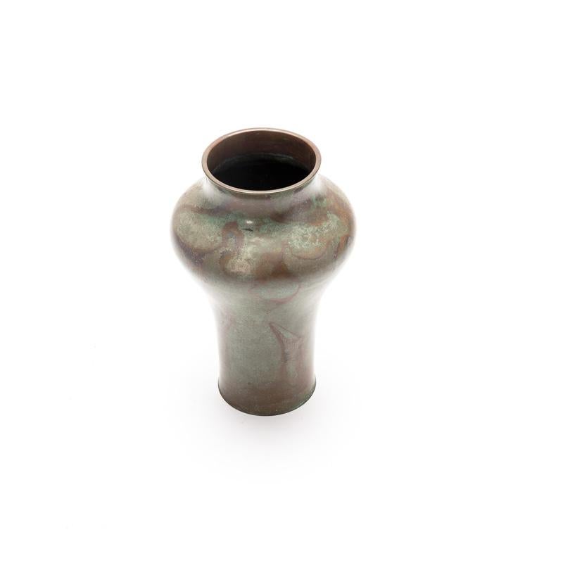 An elegantly subtle Japanese bronze vase from Takaoka. Bathed in a finely grained patina of olive green, through which a paler bluer hue reflects. Maroon swirls and veins interrupt, reminiscent of marble. The Japanese are renowned for their