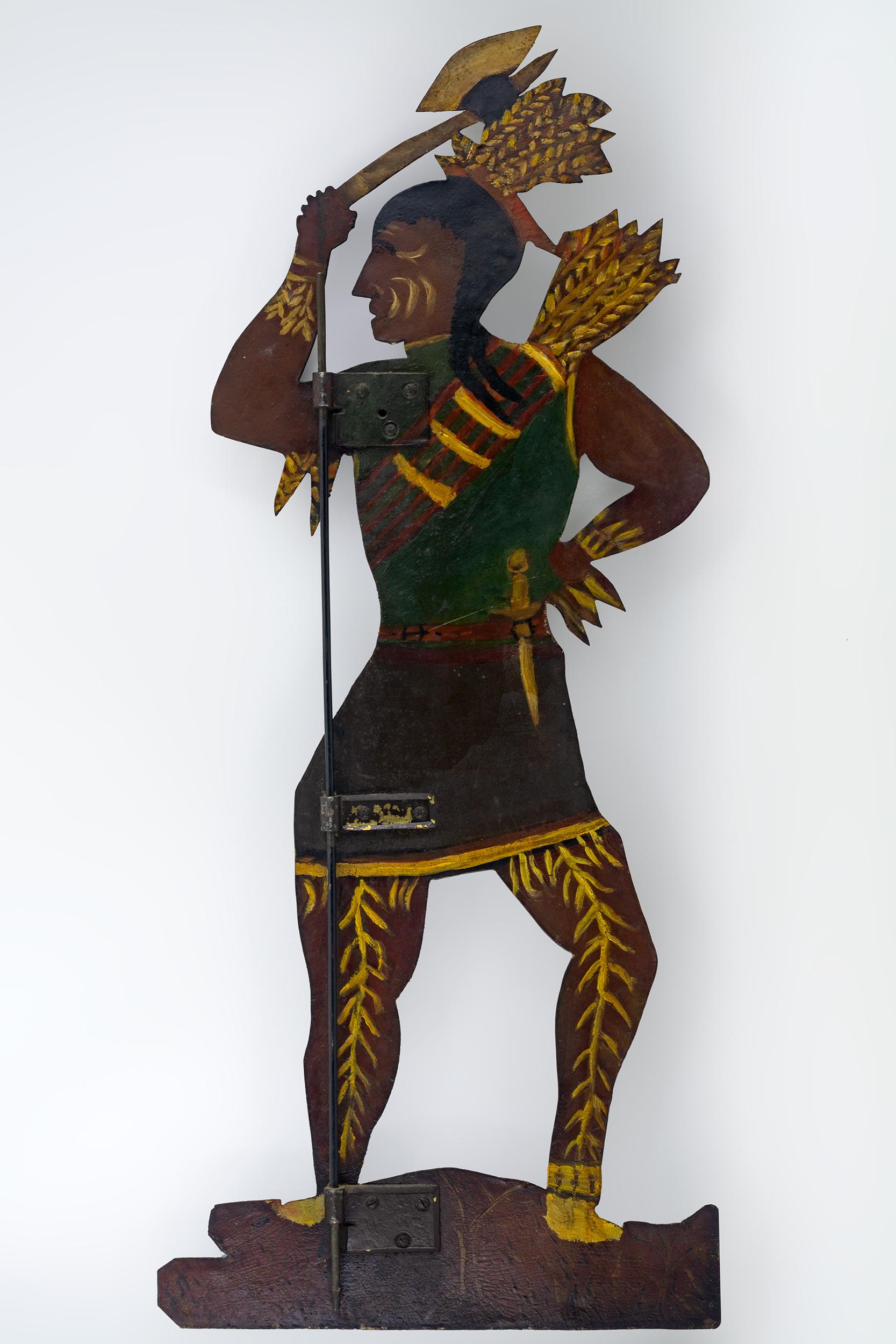 Painted Indian weathervane with a headdress, bow and
holding a tomahawk.

 