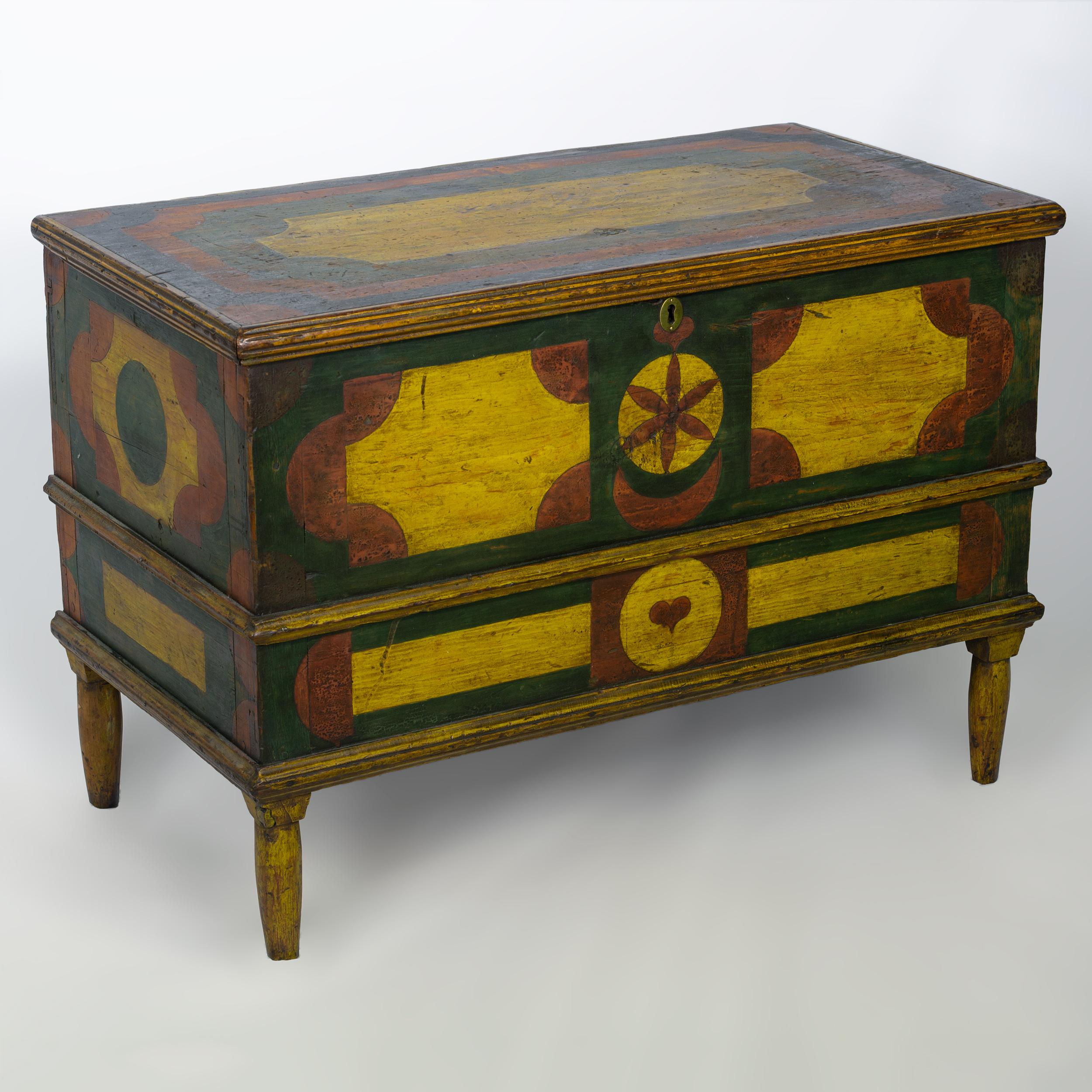 Diminutive size blanket chest with
multicolored geometric painted design
with applied molding standing on bracket base
short turned legs, Western New York,
circa 1820. Measures: 20 ½” x 32” x 17”.

  