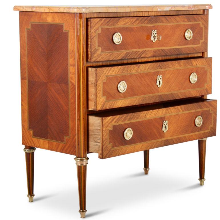 Highly inlaid, French Louis XVI-style, three-drawer commode with marble-top, circa 1920. Striking marquetry, brass accents, and a beautiful marble that complements the commode's color and patina.



    