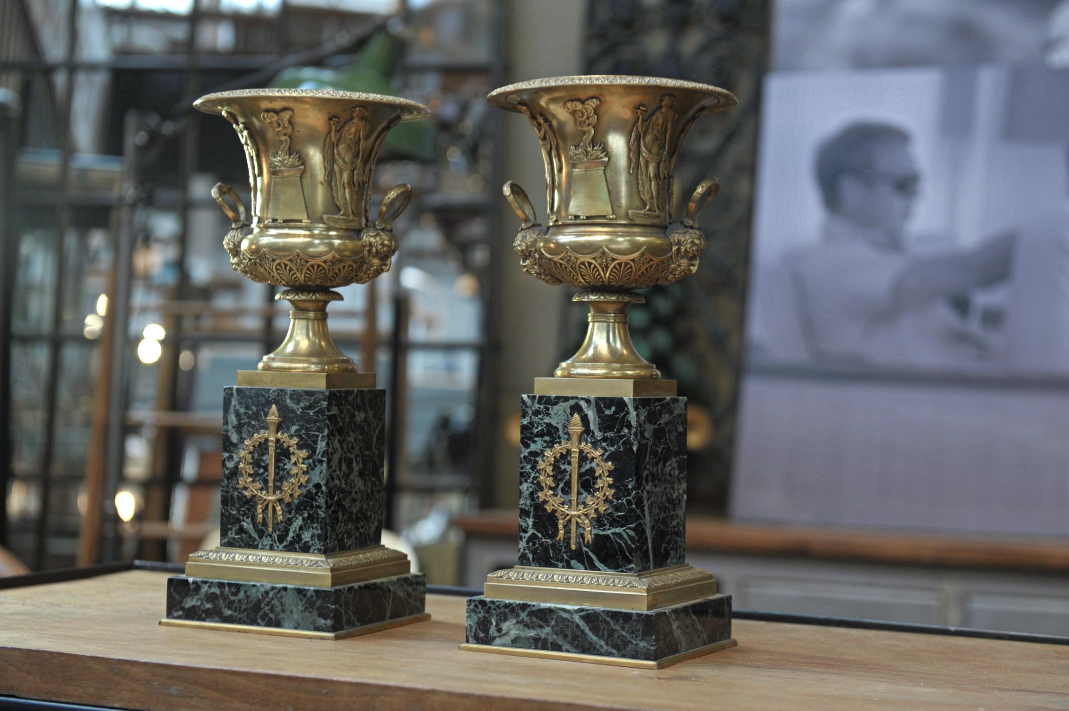 Pair of first Empire French bronze and marble urnes cassolettes, circa 1810. Beautiful detailed decor both in perfect condition.