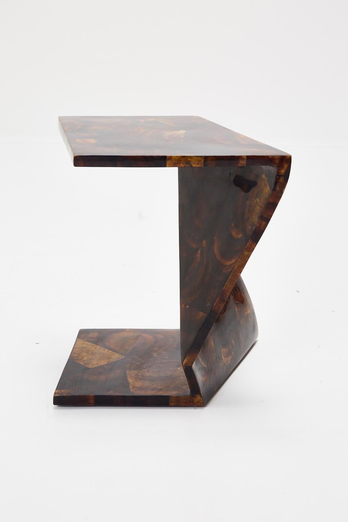 Set of two zig zag tables that can be used either as side tables or put together as a cocktail table. Tables are executed in wood, completely inlaid with young pen seashell (which resembles tortoise shell). 

Each table measures: 17 1/4 x 19 1/2 x