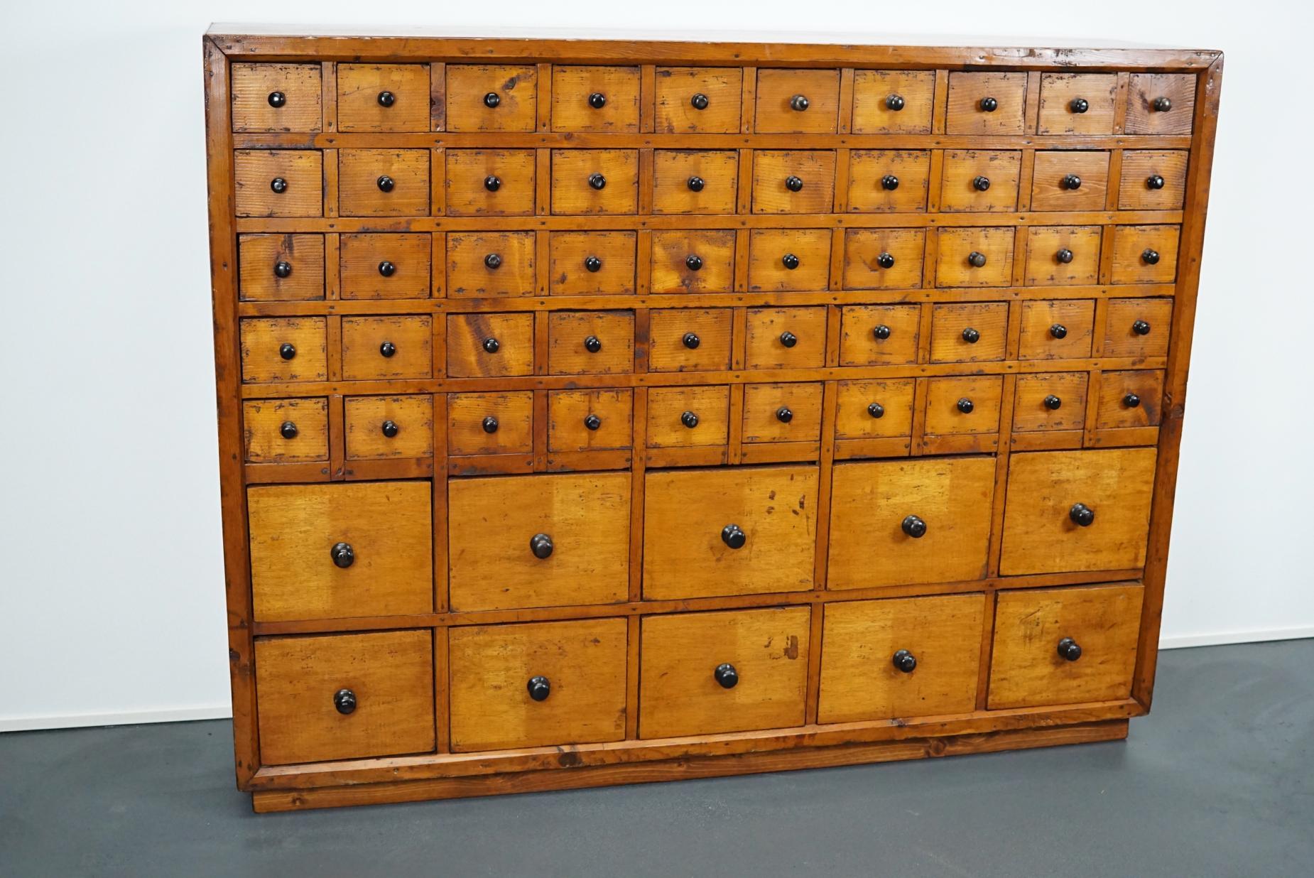 This apothecary cabinet was designed during the 1940s in the Netherlands. The piece features 60 drawers with iron hardware. It remains in a very good restored condition with signs of use and age.

The inside measurements of the drawers are: L 29 x