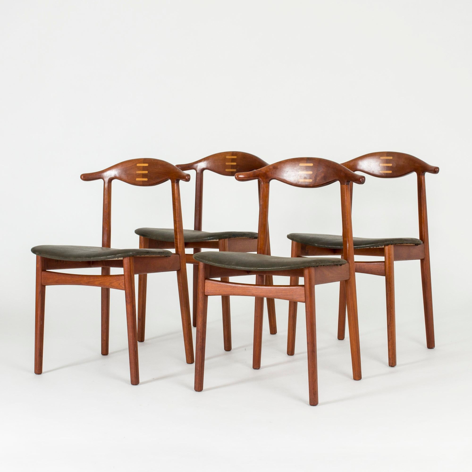Set of four dining chairs by Knud Færch, made in rosewood with a pattern of stripes in a lighter wood on the backrests. Beautifully sculpted backrests and black leather seats.