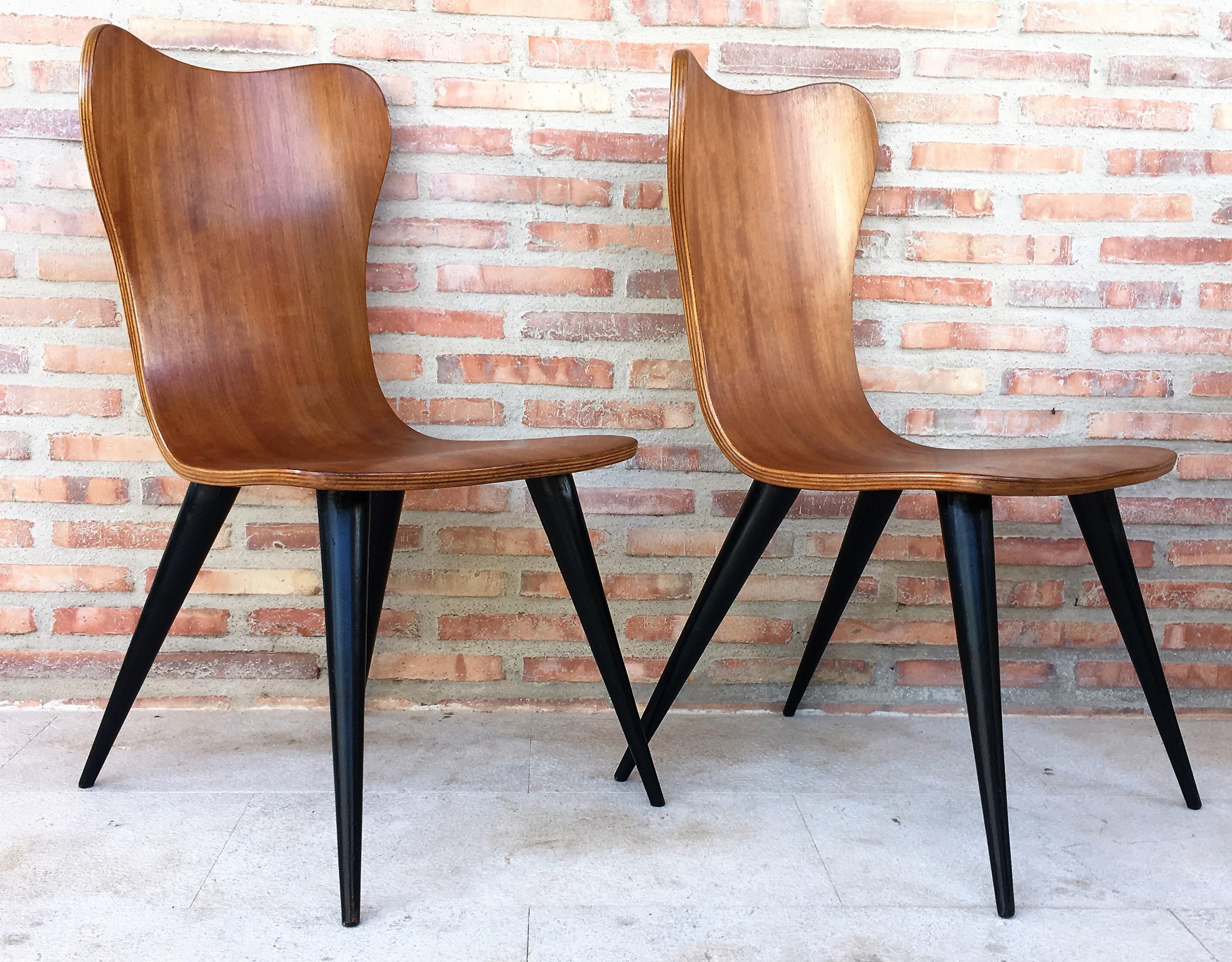 Pair of midcentury Arne Jacobsen style chairs with black tapered legs.