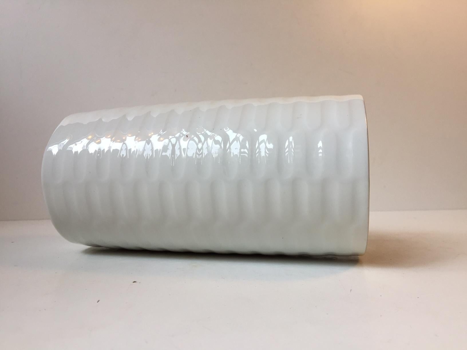 Cylindrical vase in Faience designed by Danish ceramist Anni Jeppesen and manufactured by Royal Copenhagen. Made in Denmark during the 1970s. Fully signed (AJ), numbered and marked to its base. Stylistically it is reminiscent of Axel Salto 's later