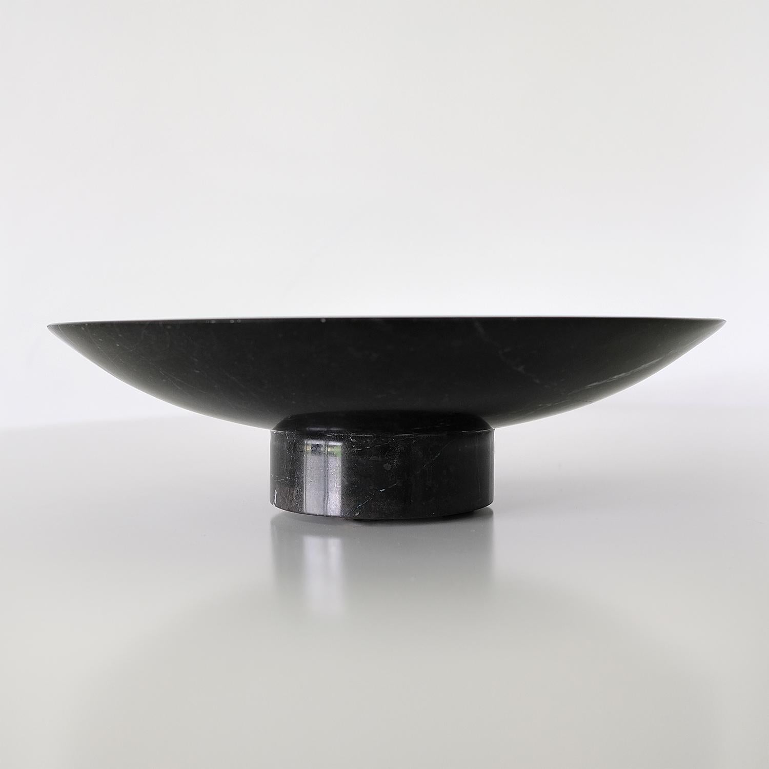 Minimalistic round footed serving tray/platter in polished black marble from the Mountainscapes collection of one-of-a-kind stone tabletop objects.