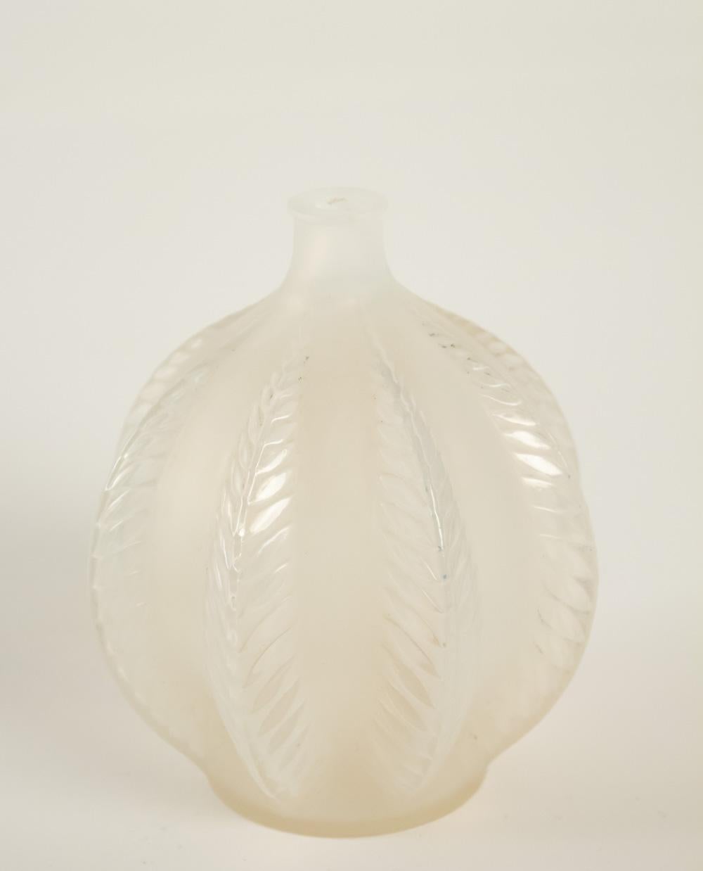 Rene Lalique vase Malines: 12 cm tall apparently opalescent glass mold blown with vertical leaf motif
Signed. Model: 957, circa 1924. Model created in 1924.
Measures: H 12 cm
Bibliographie:
Félix Marcilhac, “René Lalique, 1860-1945, maître