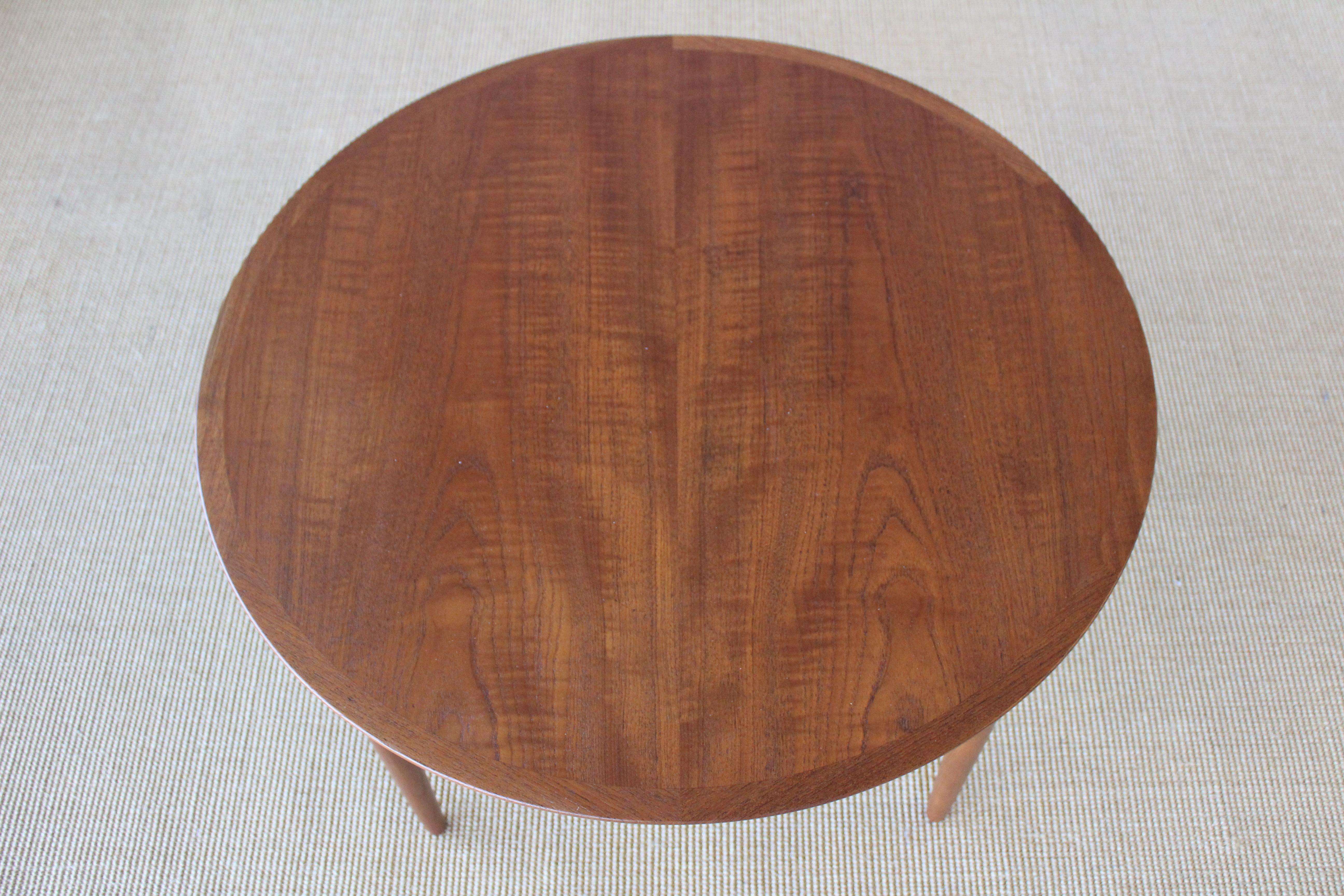 1950s Danish teak coffee table with a caned lower shelf. Recently refinished.
  