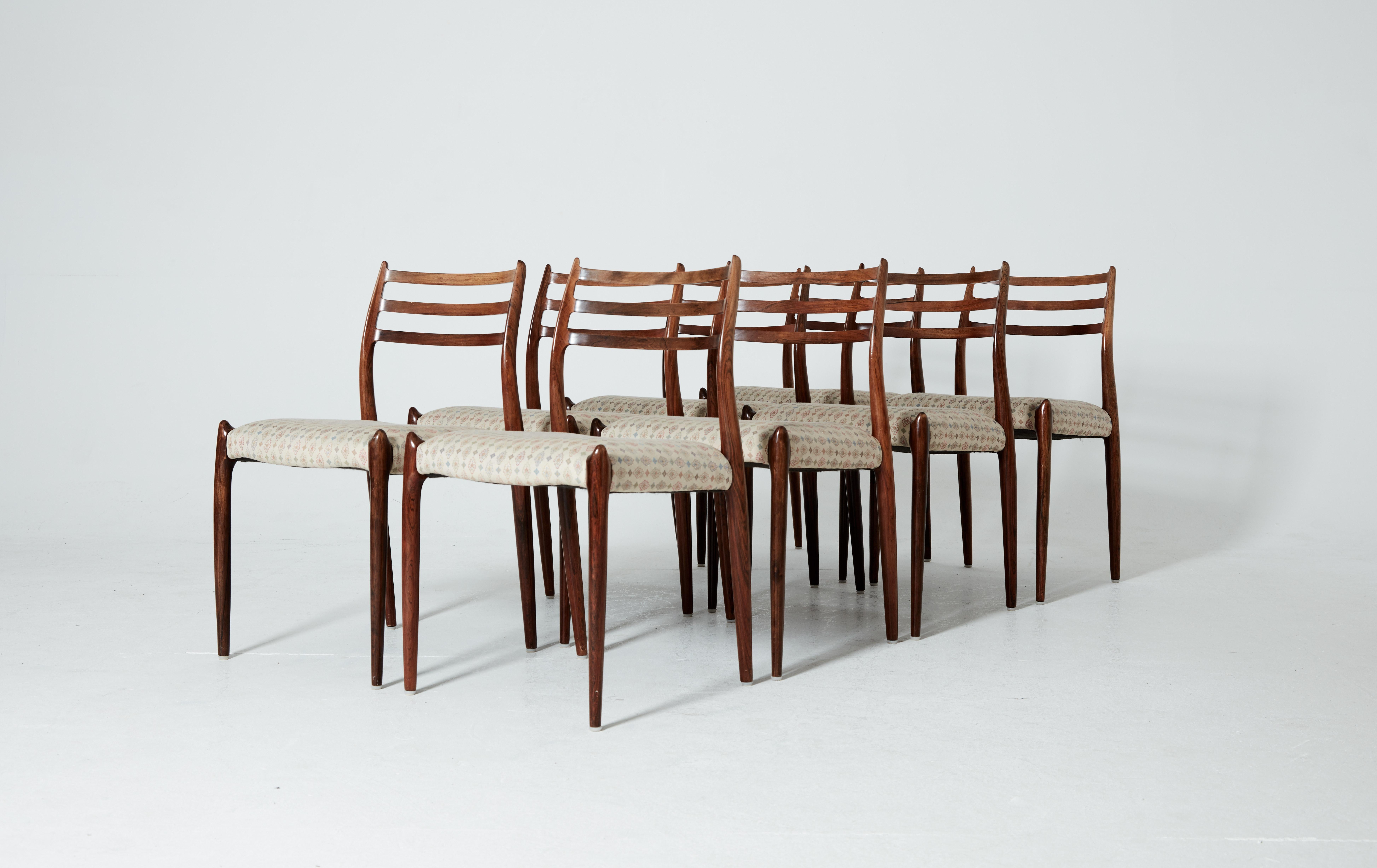 A set of eight rosewood N.O. Møller 78 side chairs. 1962 for J.L. Møllers Møbelfabrik, Denmark. Rosewood frames and fabric seat covers. We can change the seat covers to leather, vinyl or cord if you wish.