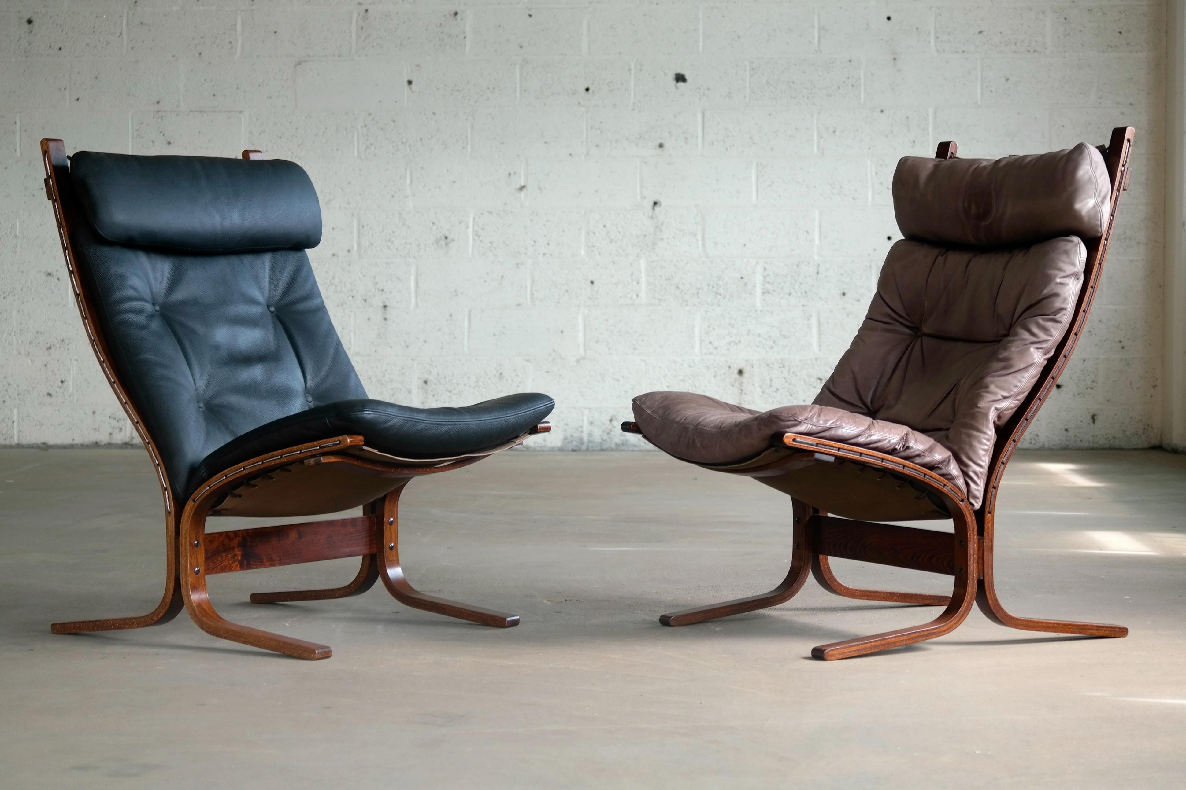 Fantastic set of easy/lounge chairs designed by Ingmar Relling for Westnofa in 1965. One chair is in black leather and the other in grayish brown and while not matching in color they compliment each other perfectly. Both chairs have matching frames