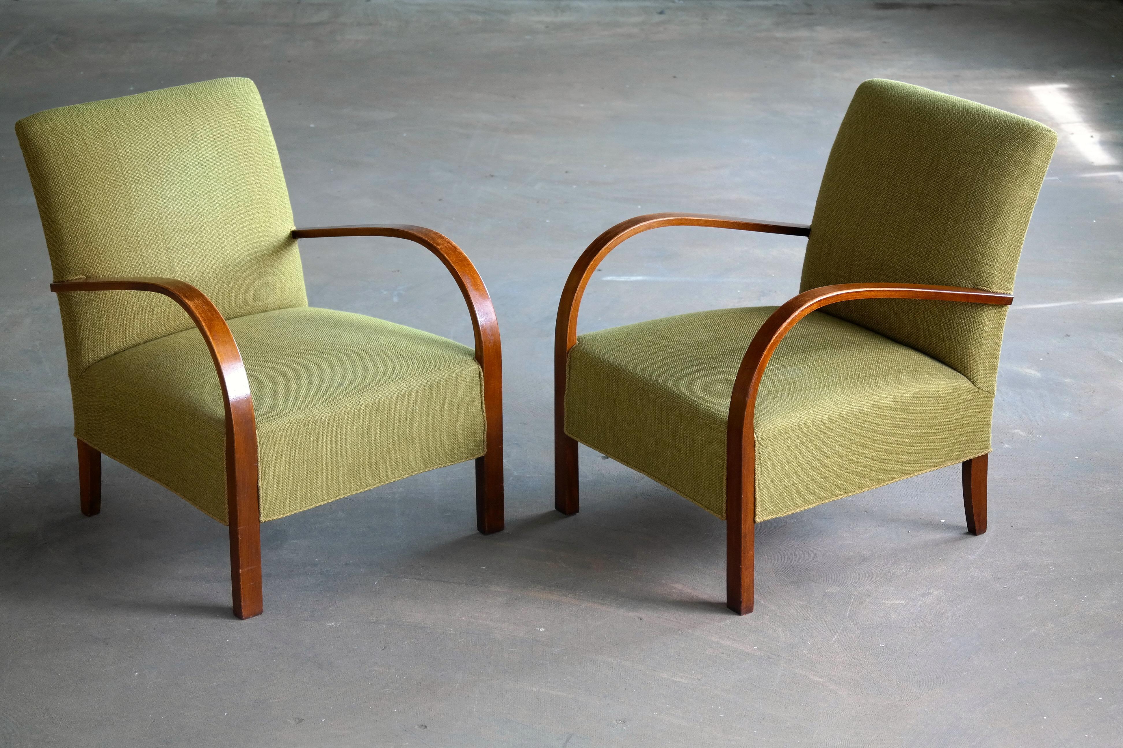 Superb pair of Danish late Art Deco early midcentury chairs from the early 1940s with spring cushions and solid beech wood armrests and legs. We just love the simple yet very refined elegant design of these chairs. Which will work very well in