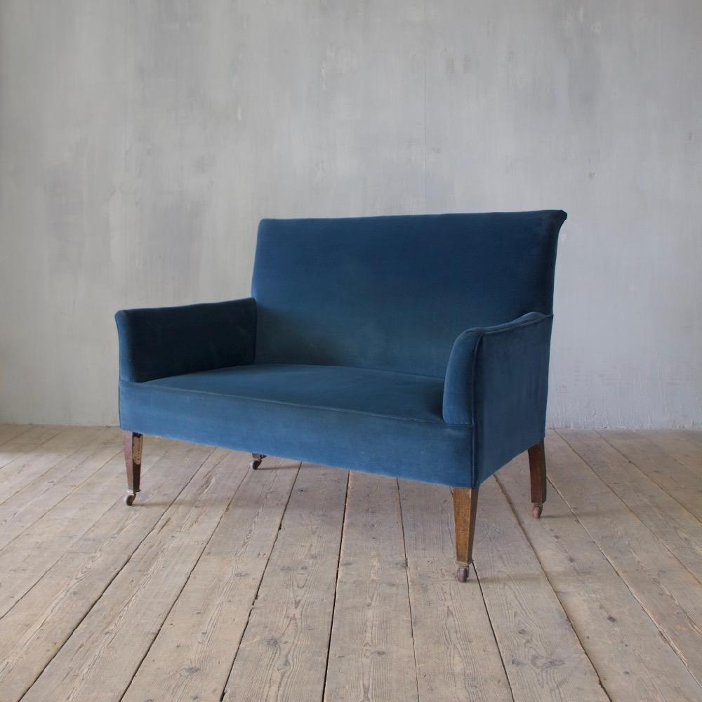 An Edwardian sofa of unusually small proportions. Upholstered three years ago in Fox Linton/cotton velvet 14 Prussian blue, England, circa1910.
