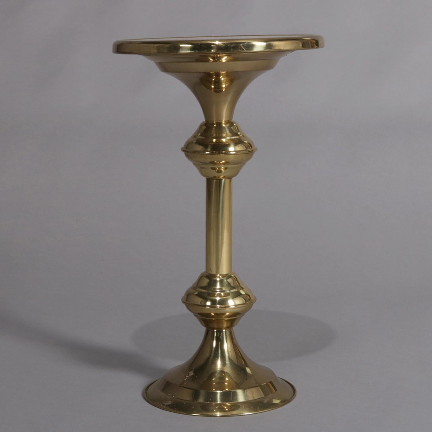 Hollywood Regency side table features brass construction with round dish top display over turned column and seated on stepped and flared weighted base, 