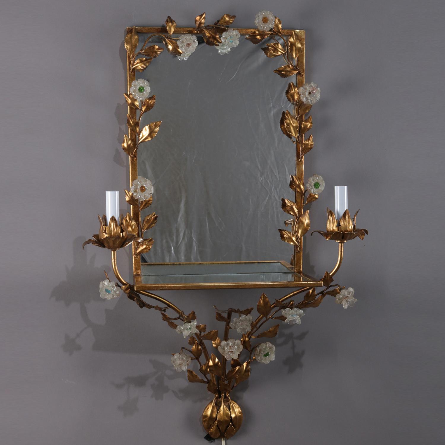 Vintage Italian candle light sconce features mirror with gilt metal frame decorated in foliate leaf and vine having attached crystal flowers and terminating at base with gathered bouquet, mirrored display shelf is flanked by electric candle lights