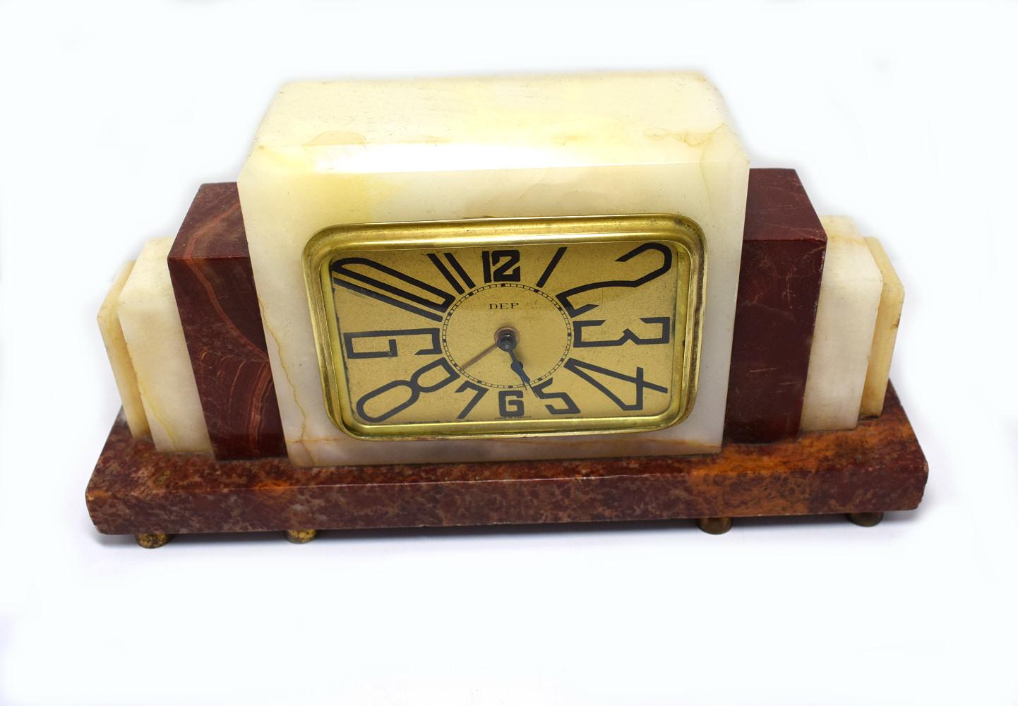 Very striking 1930s Art Deco French clock by Dep. The case is solid multicolored onyx, the bezel and face are in gold tone metal. Very iconic Art Deco stretched numerals. This clock is a really cute size and ideal as a bedroom clock or side table,