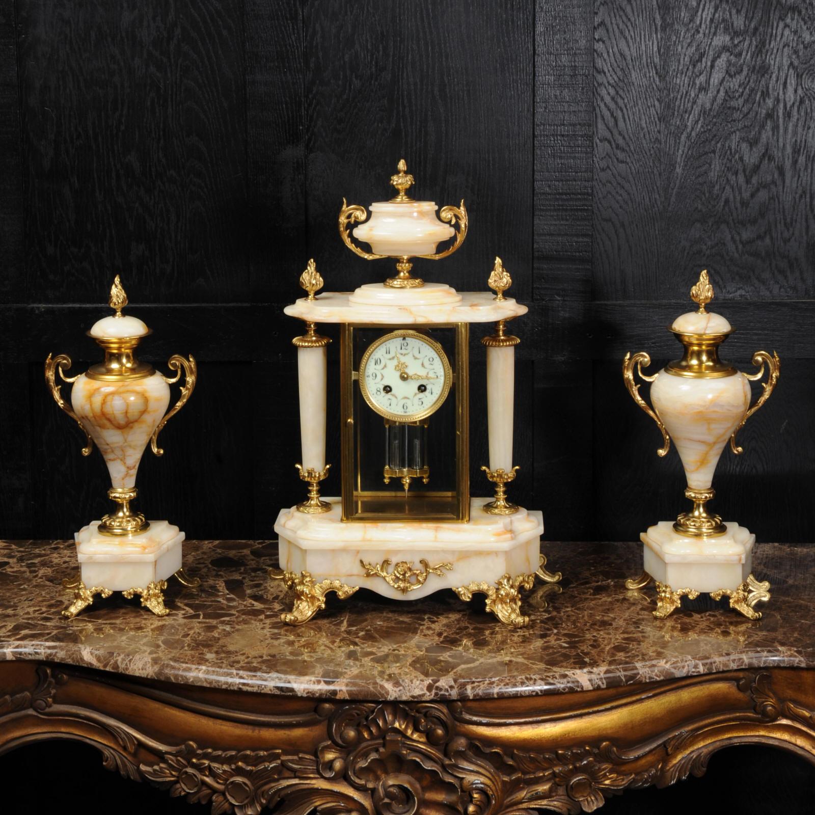 A beautiful original antique French four glass regulator clock set of the most beautiful cream and orange specimen onyx by A. D. Mougin. It is classical in style with ormolu mounts of flame finials, swept acanthus feet and beveled glass to show the