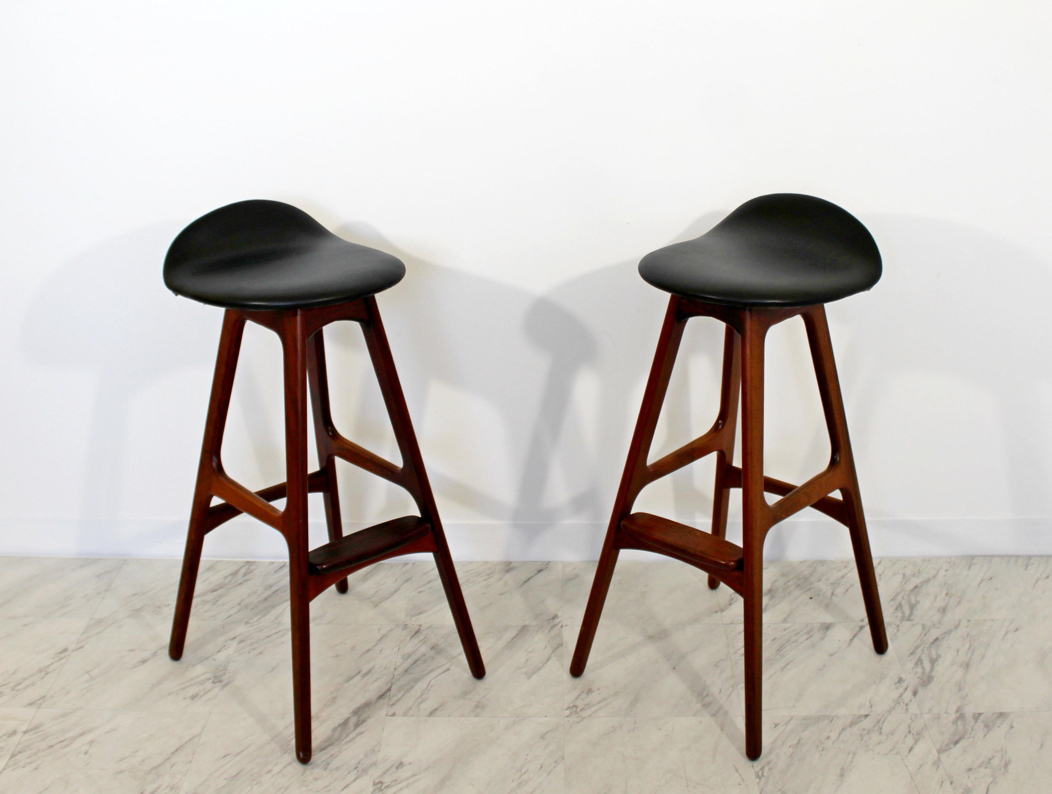 For your consideration is a sleek pair of teak and rosewood and black leather bar stools, by Erik Buch, made in Denmark, circa the 1960s. In excellent condition. The dimensions are 14