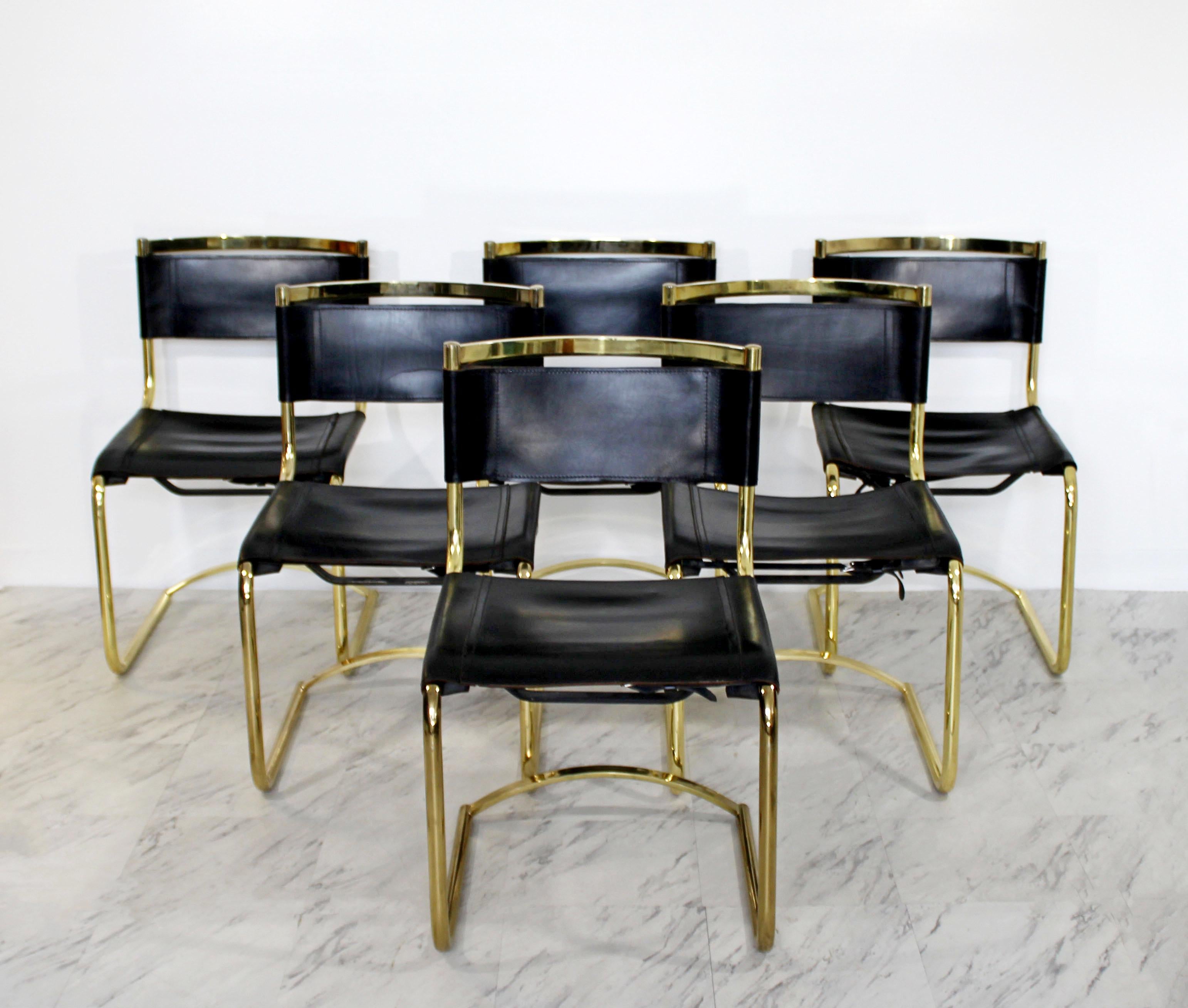 For your consideration is an incredible, rare, set of eight side dining chairs, made of curved brass and black leather, in the style of Breuer, circa 1970s. In very good condition. The dimensions are 19