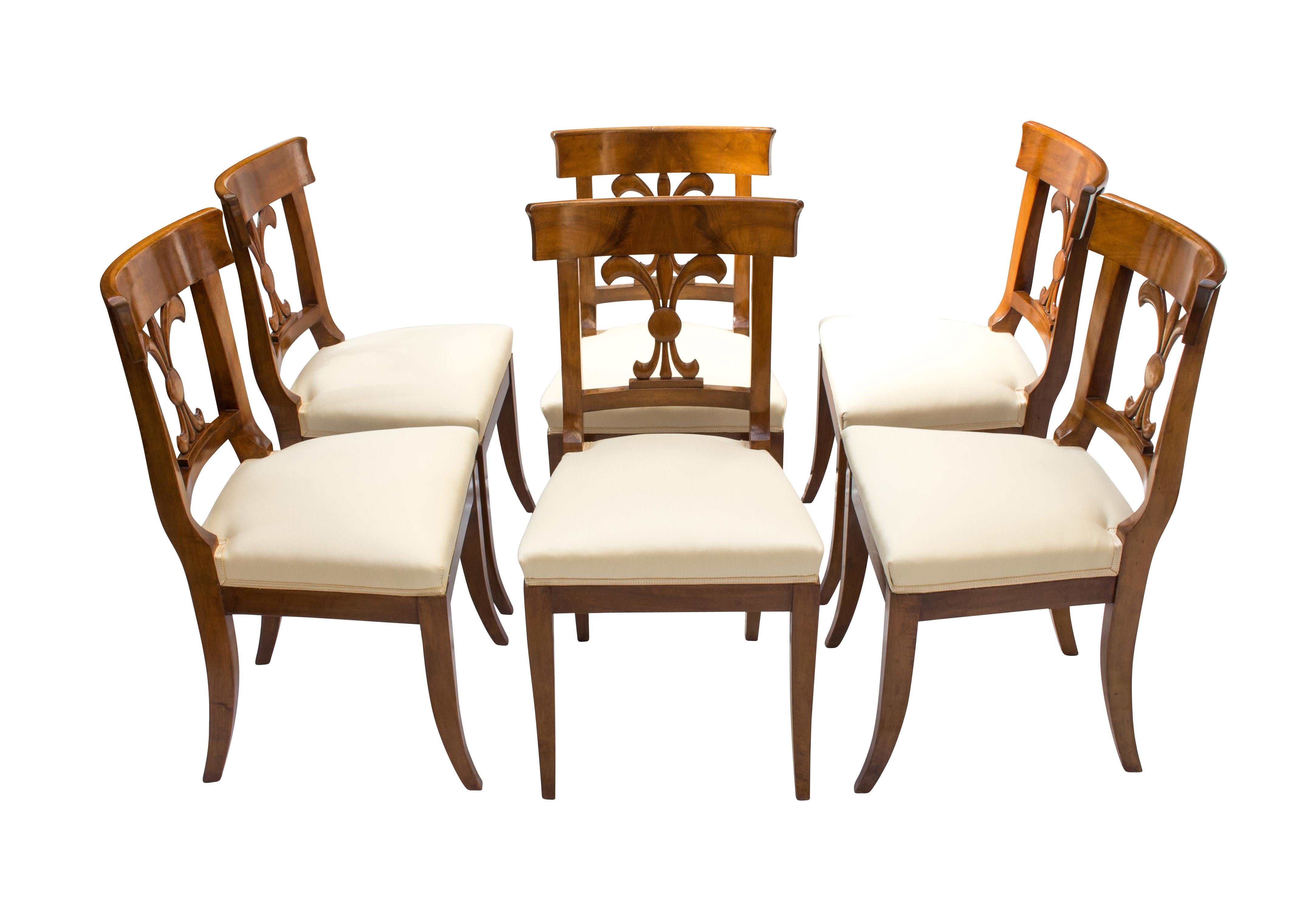 Set of six chairs, Biedermeier, solid walnut-wood. The chairs are new upholstered in the traditional style with straps and feathers. In very good restored condition. 
Measure: Seat height 47cm.