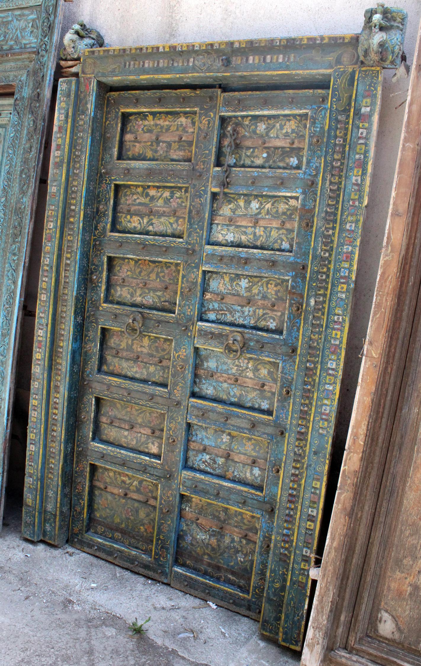19th century antique Indian hand-carved wooden coffered main door with brass decorations.