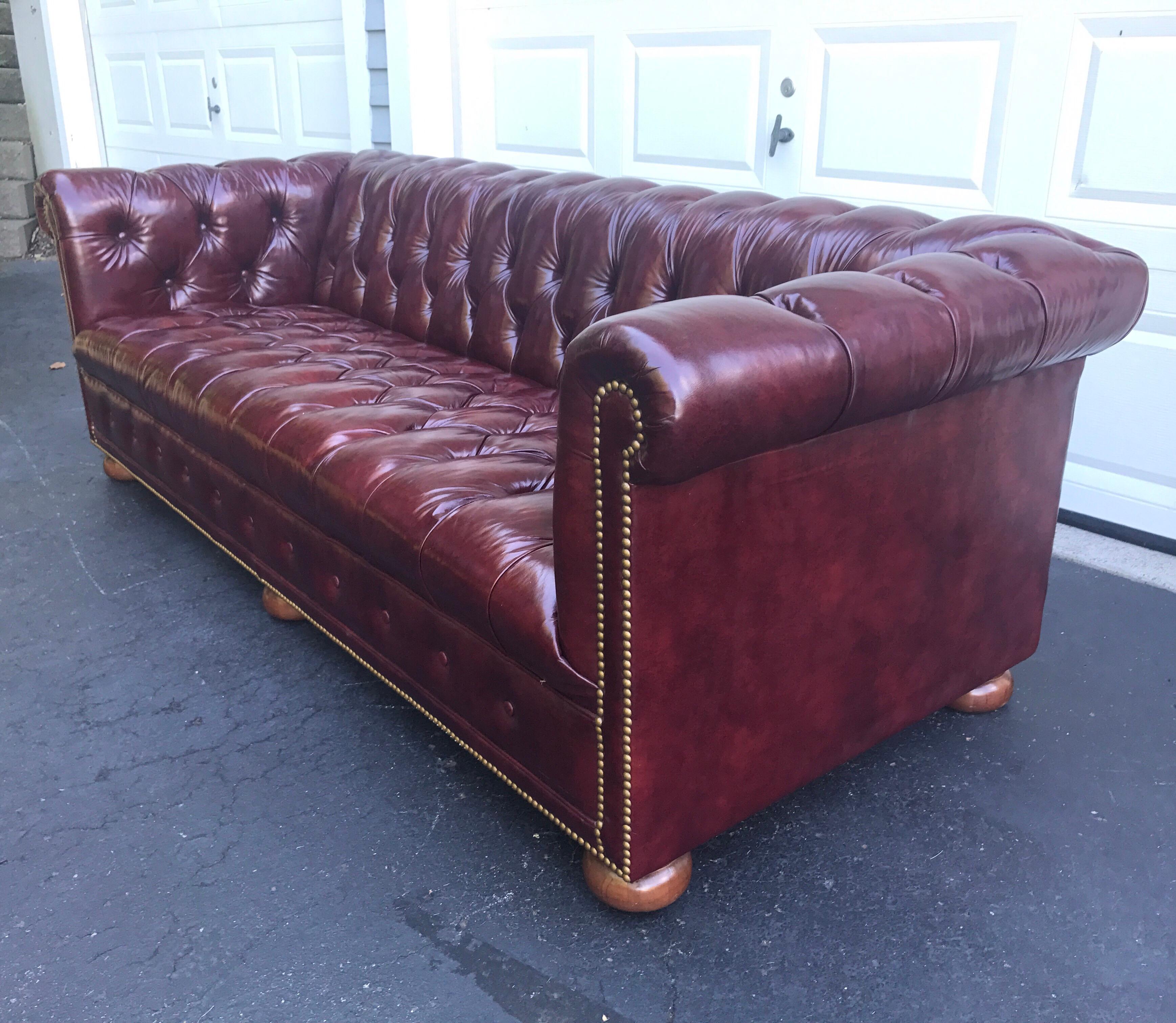Magnificent condition coveted oxblood merlot leather chesterfield sofa with brass nailheads.