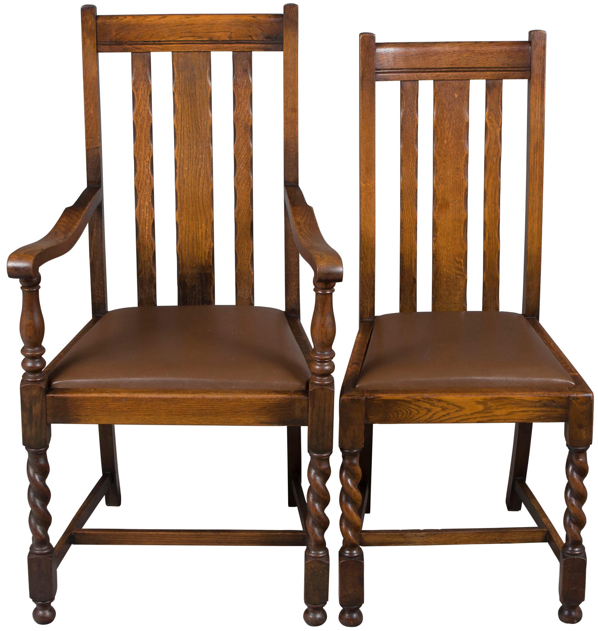 A traditional set of four English oak antique barley twist dining chairs. This set consists of 3 side chairs and an armchair. All four were made with barley twist front legs and currently have brown leather upholstered seats. The upholstery looks