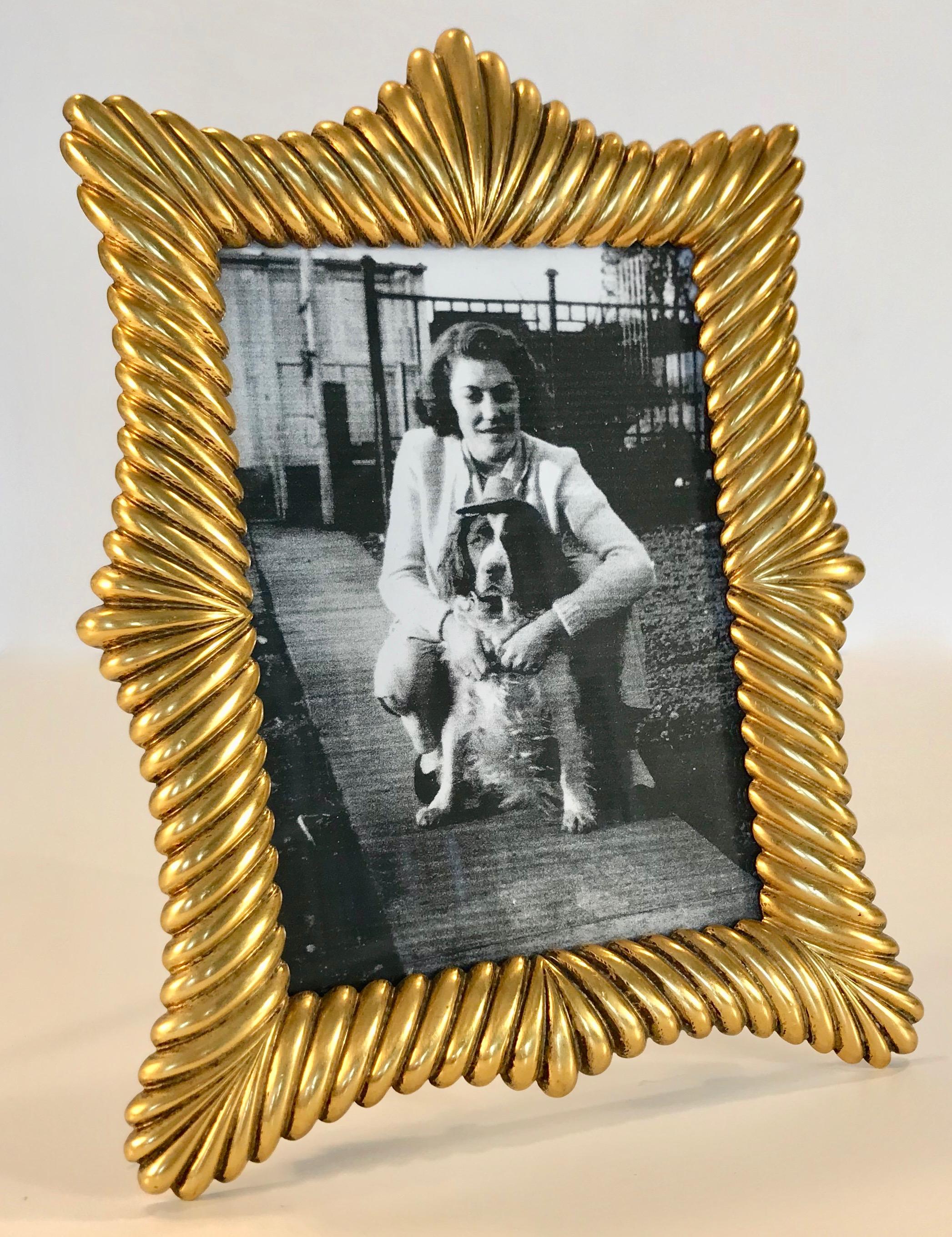 Beautiful French gilt bronze picture frame in Belle Époque style. Very well crafted and weighty, this frame has a beautiful warm d'oré gilt finish with a lovely patina. Original condition with easel back. 

Measures: 7.5