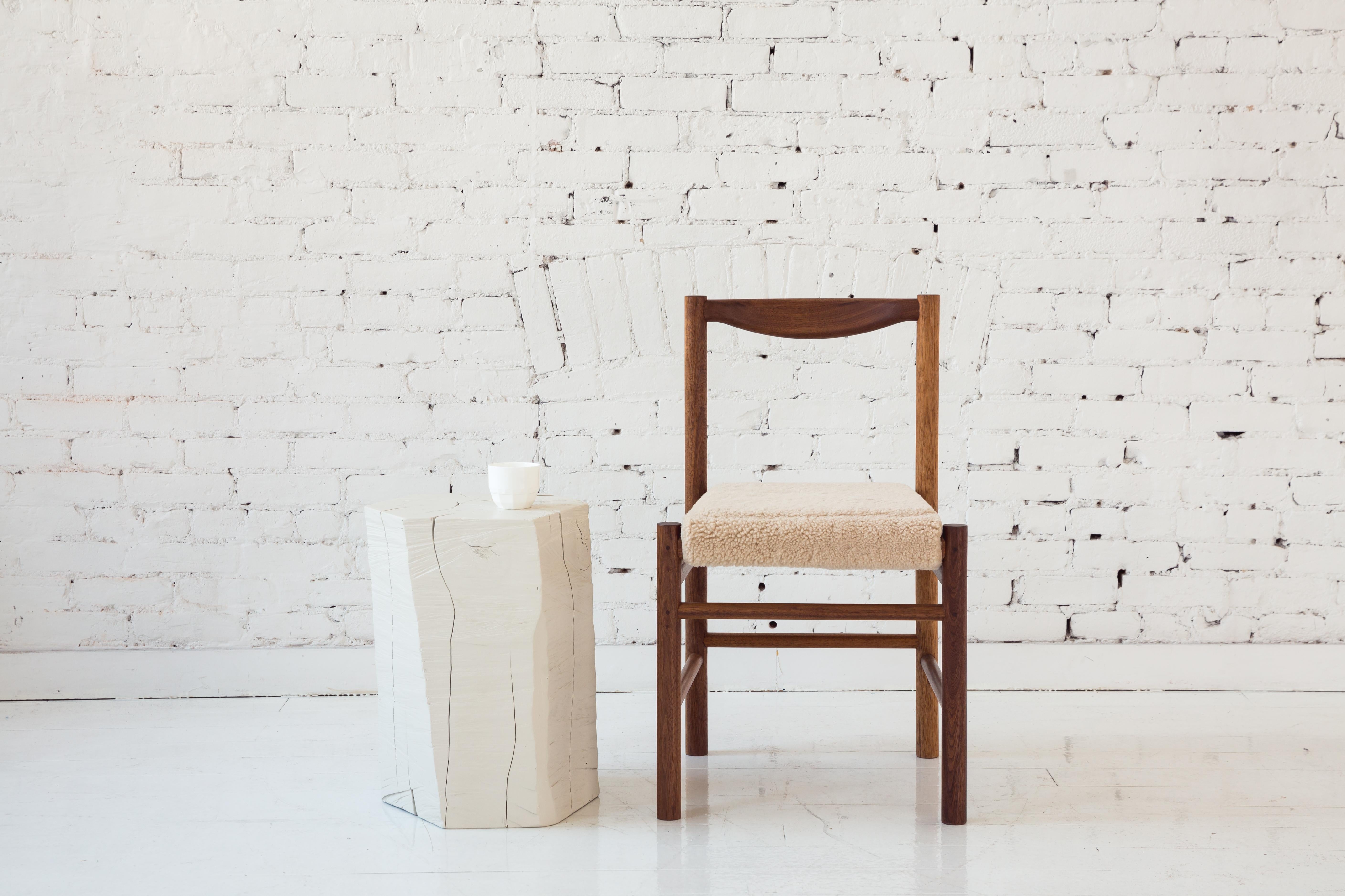 Shaker inspired wood side chair with comfortable contoured backrest. Option for a plain wooden seat pan or a seat pan with a low profile leather or shearling pad. This chair's simplicity makes it versatile to work perfectly in many different