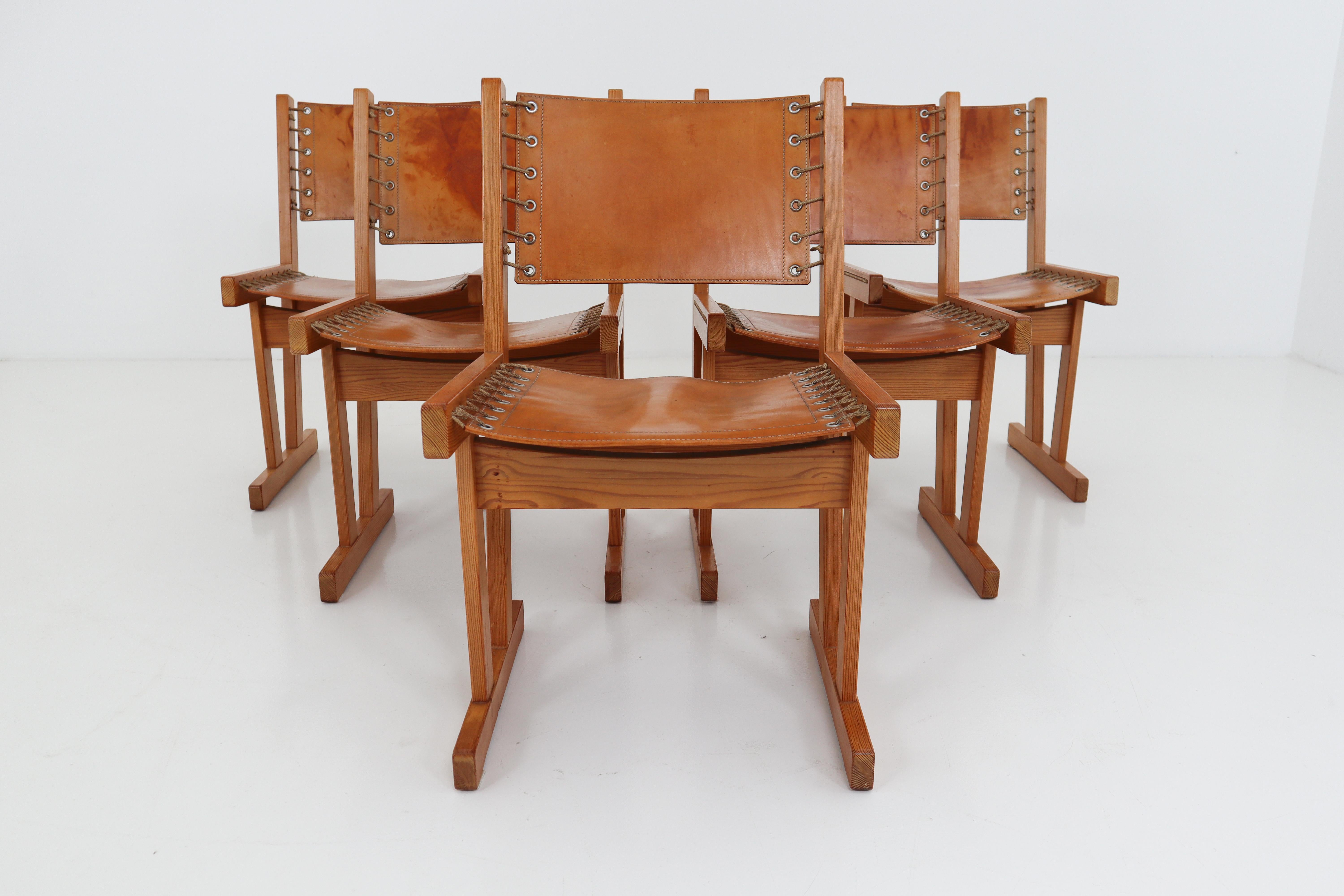 Set of five safari chairs in absolutely gorgeous thick cognac saddle leather and solid pinewood, circa 1970s. Chairs are in very good condition with incredible patina and natural wear to the leather adds tons of character.