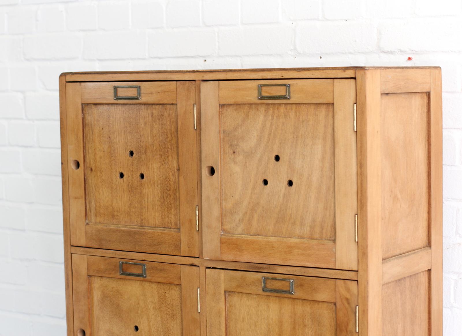 English oak school lockers, circa 1930s.

- Solid oak frame with oak ply faces
- Original brass card holders
- Eight individual compartments with shelves
- English, circa 1930s.
- Measures: 77cm wide x 35cm deep x 165cm tall
- Each