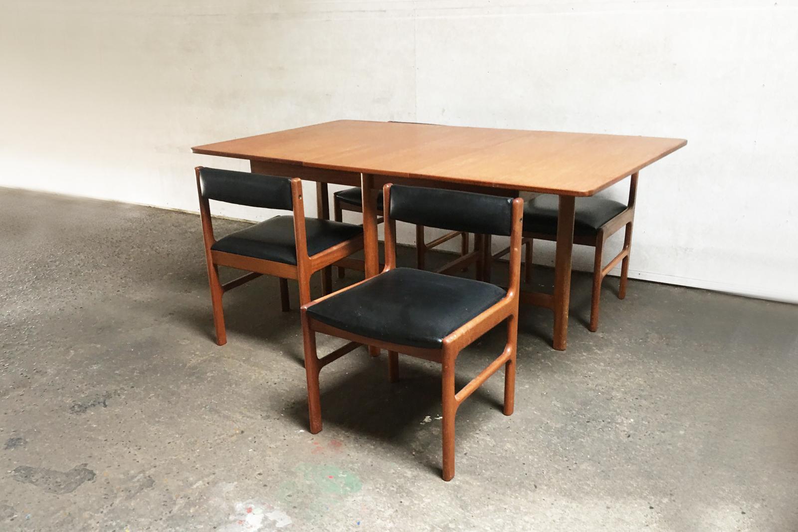 A very cool Danish influenced dining set by respected Scottish maker Mcintosh of Kirkcaldy. The chairs are well padded and upholstered in the original black vinyl and have a low distinctive low back. They can slot underneath the table when not in