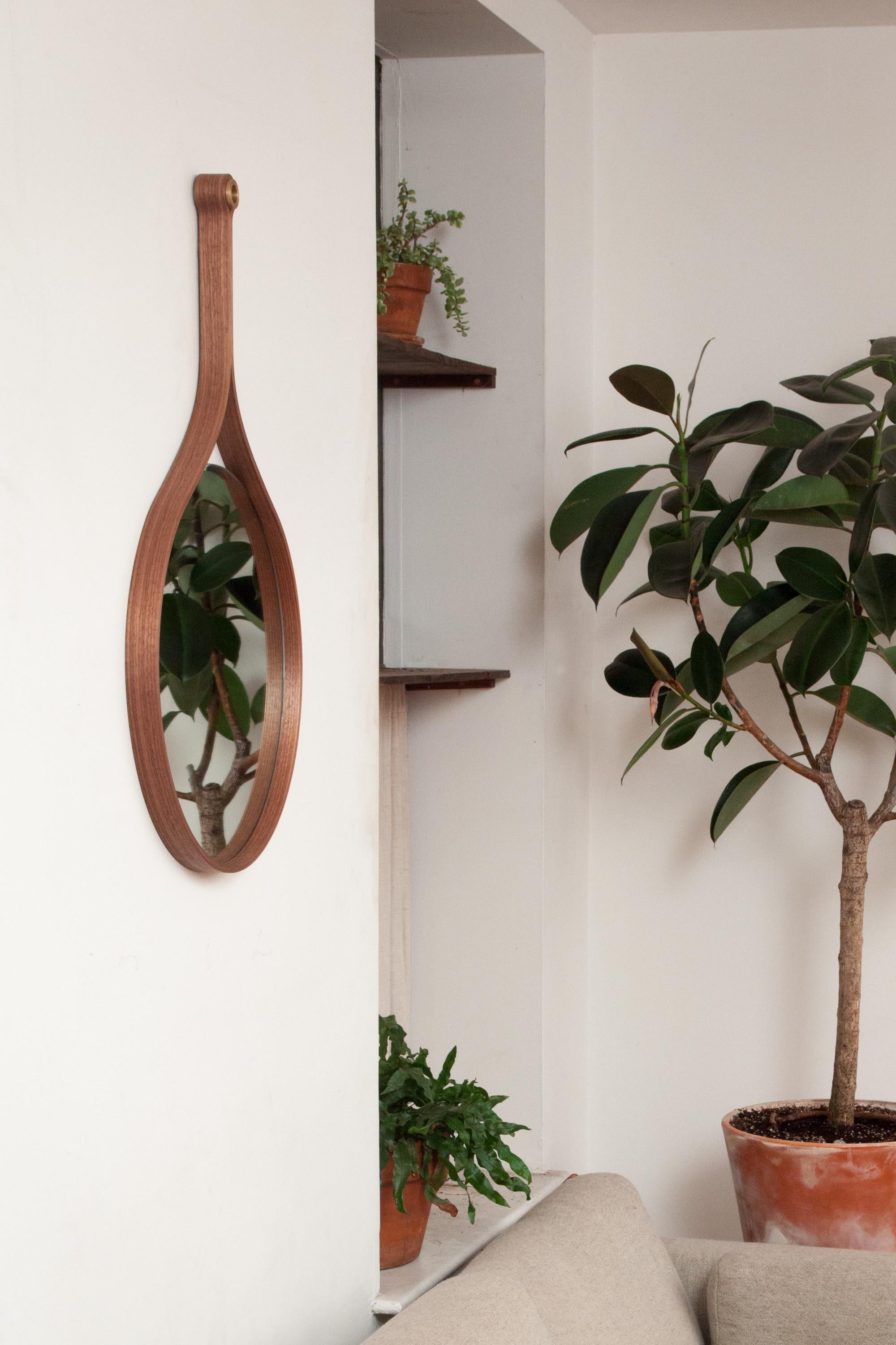 The loop mirror’s elegant, curved frame encloses the circular mirror and loops up to surround the echoing circle of cast bronze above, lending the mirror its name.

Measures: 18 inch. Handcrafted in our Brooklyn furniture shop.