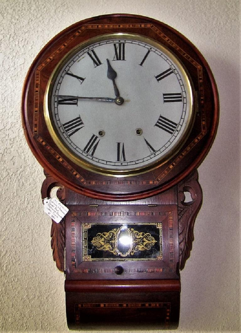 Gorgeous American 19th century timepiece, with an Irish connection!!

Made from exotic hardwood and beautifully inlaid with various wood patterns of satinwood etc. In the style of Tunbridge ware.

Lovely hand painted glass gallery to front with
