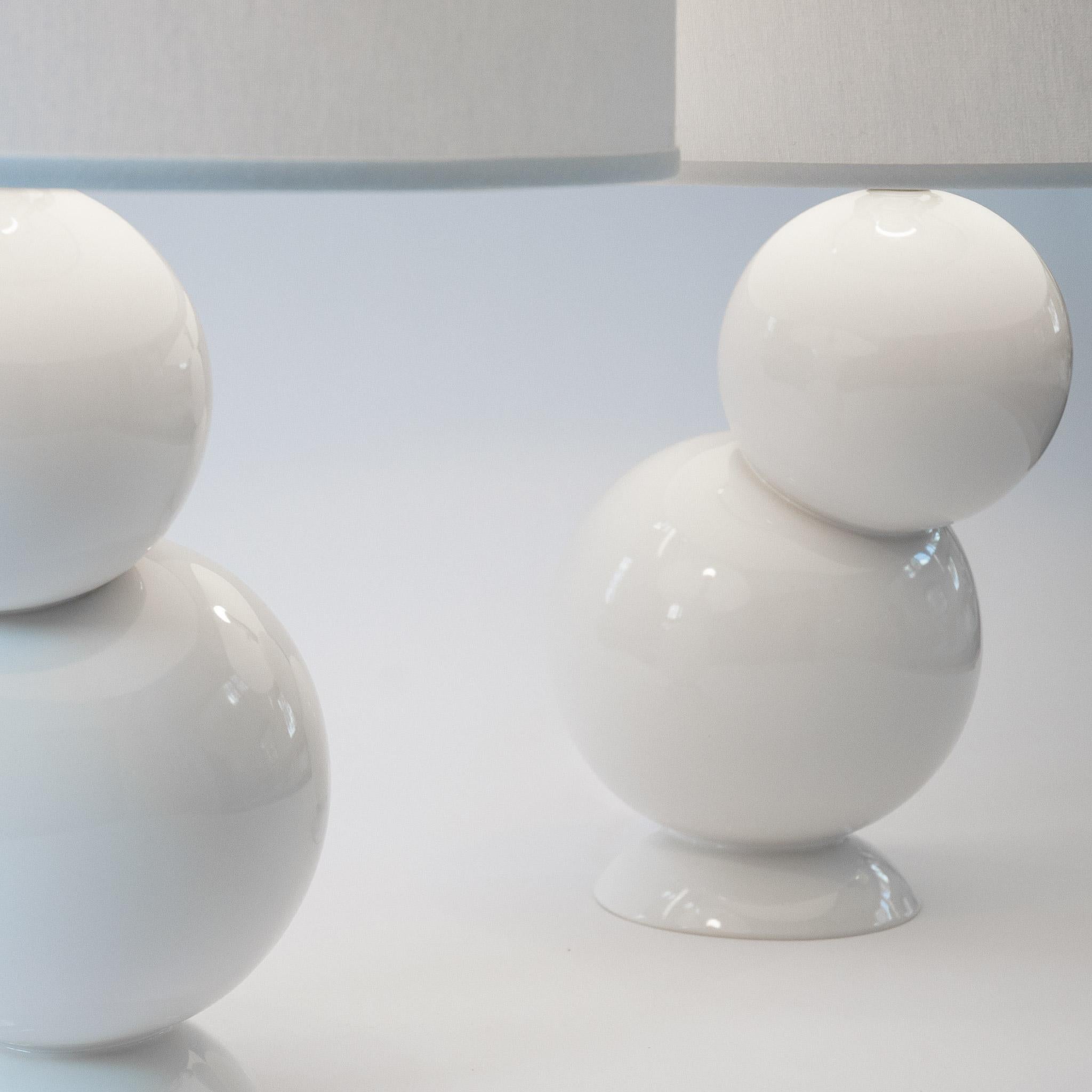 Our homage to Space Age design, the white bubble table lamp pair in stoneware is divine whether bookending a credenza or topping off nightstands. Assembled by hand from stoneware orbs that are placed offset from their base, and finished with a white